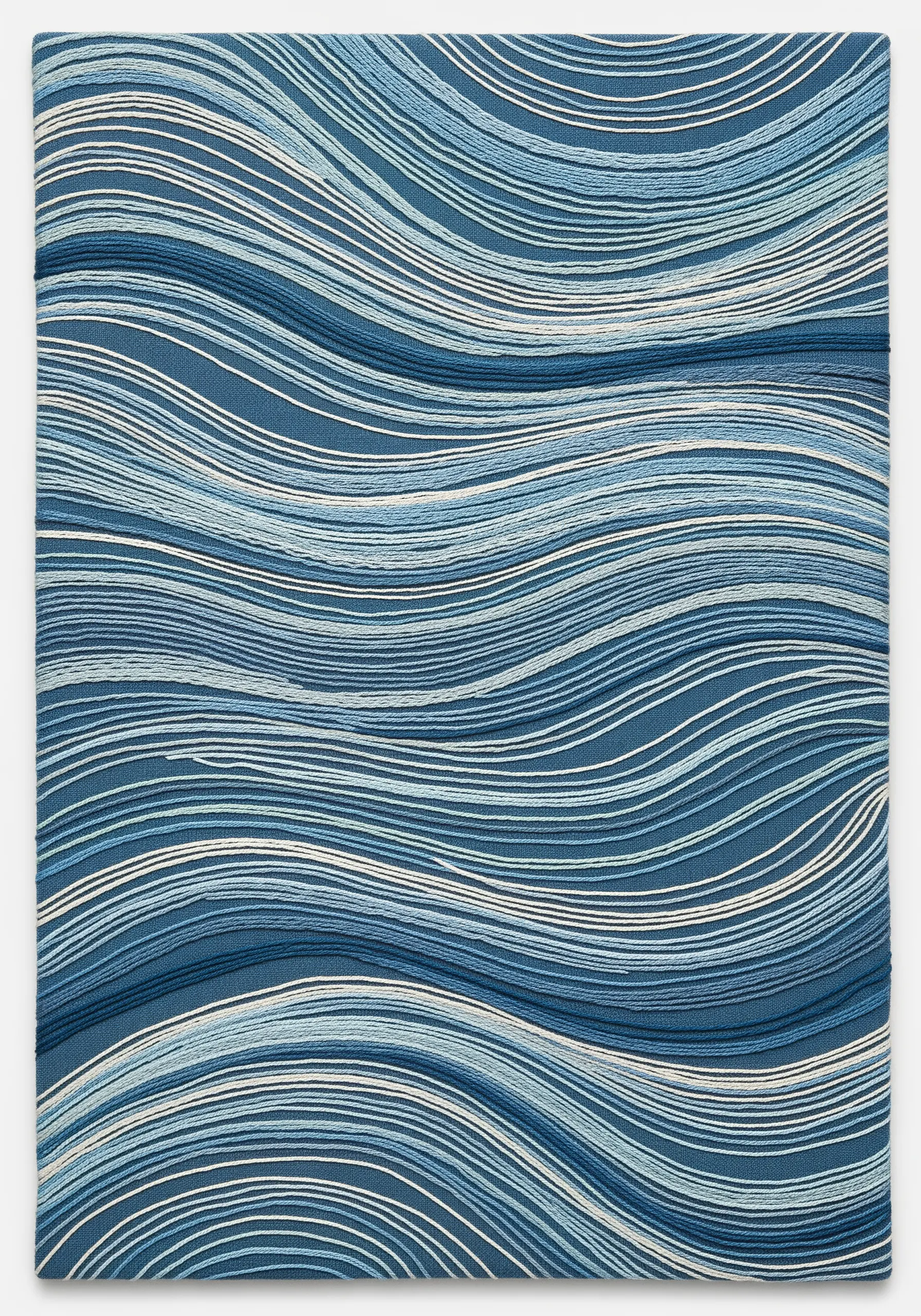 A square textile piece with layered, wavy horizontal stitches in various shades of blue and white.