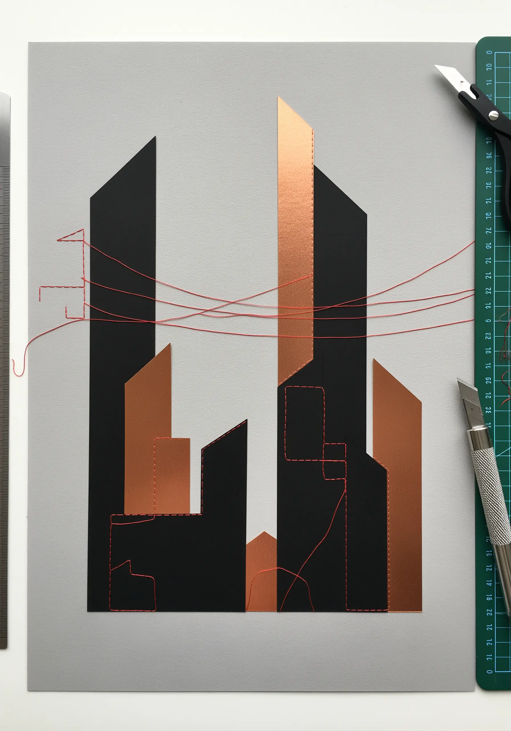 A minimalist architectural collage in black and copper paper, accented with abstract red stitching.
