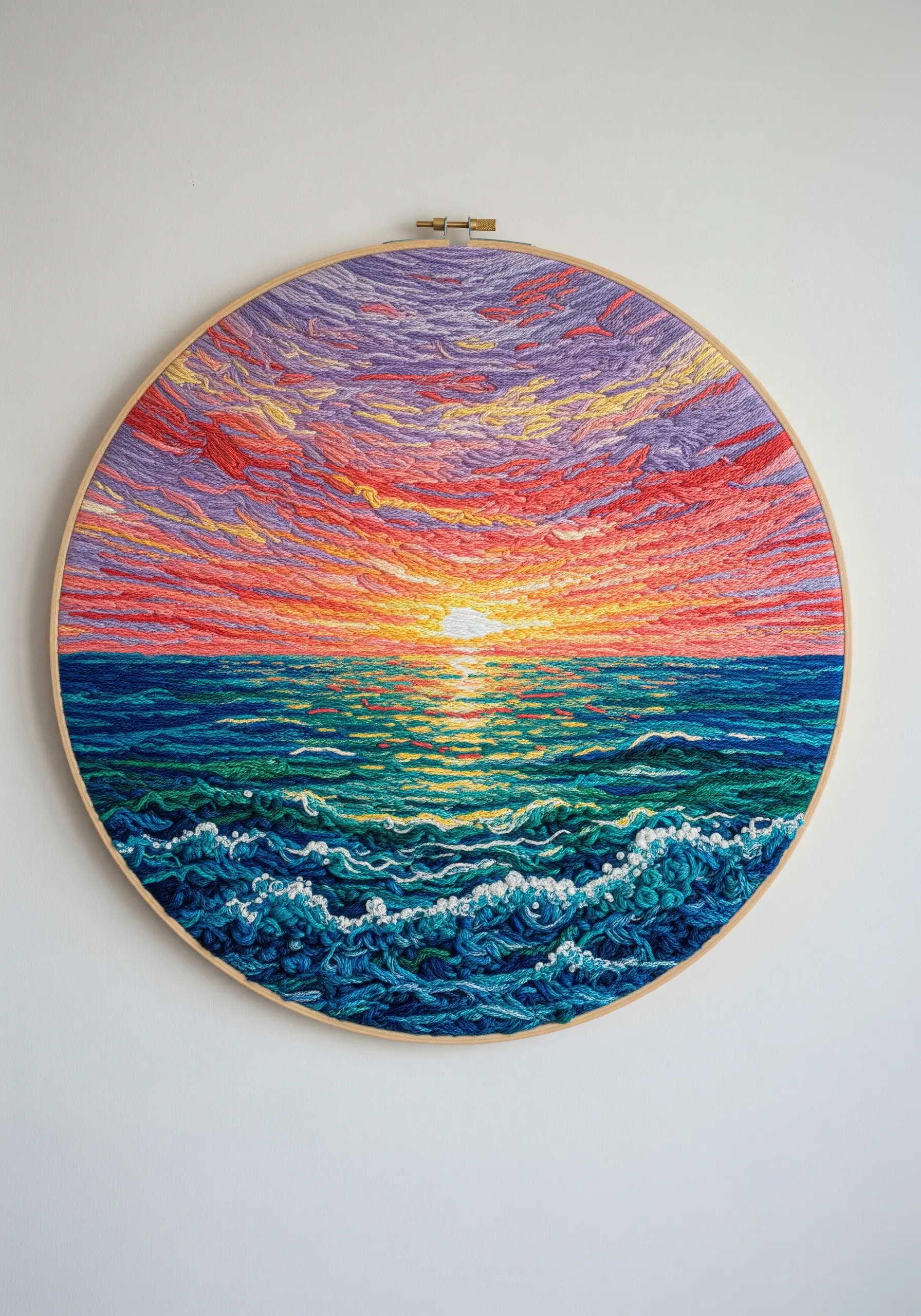 A densely embroidered sunset over the ocean, using thread-painting techniques.