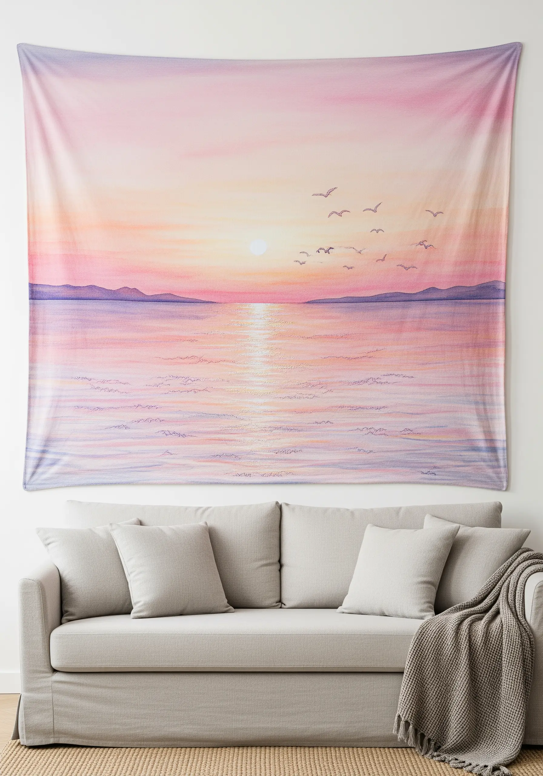A large embroidered tapestry of a soft, pastel sunset over the ocean.