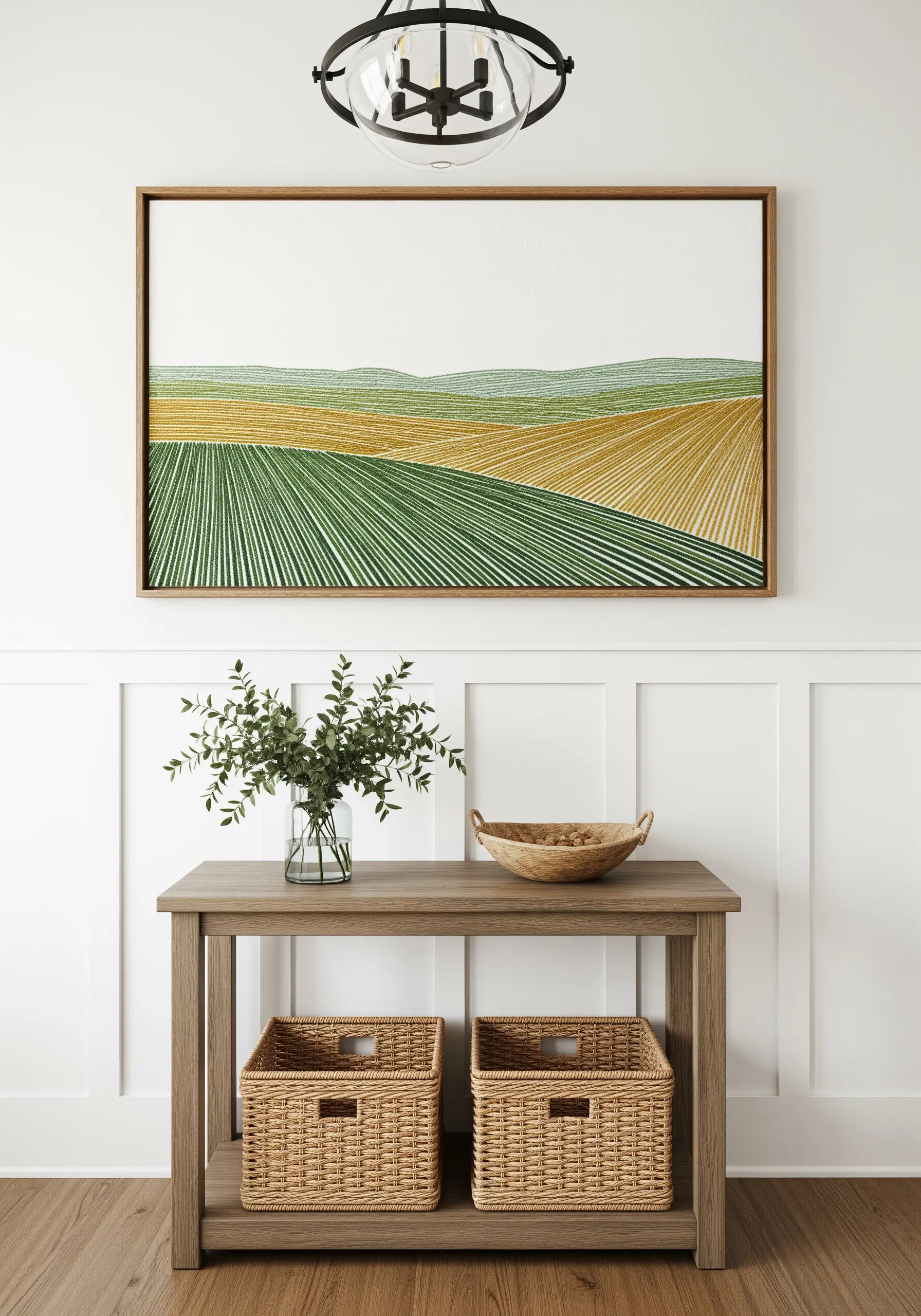 A large framed embroidery of rolling green and gold fields, created with lines of directional stitches.