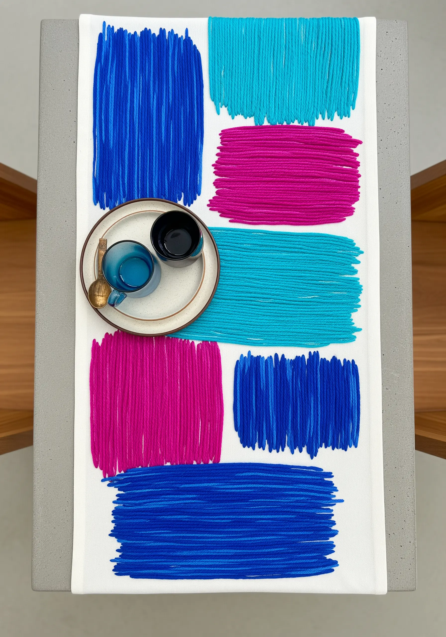 Abstract rectangular color blocks in blue, magenta, and cyan stitched on a white runner.