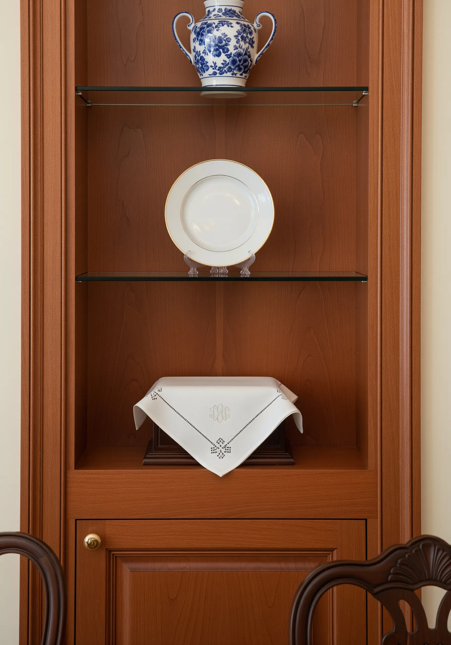 An elegant white-on-white embroidered monogram on a fine linen napkin.