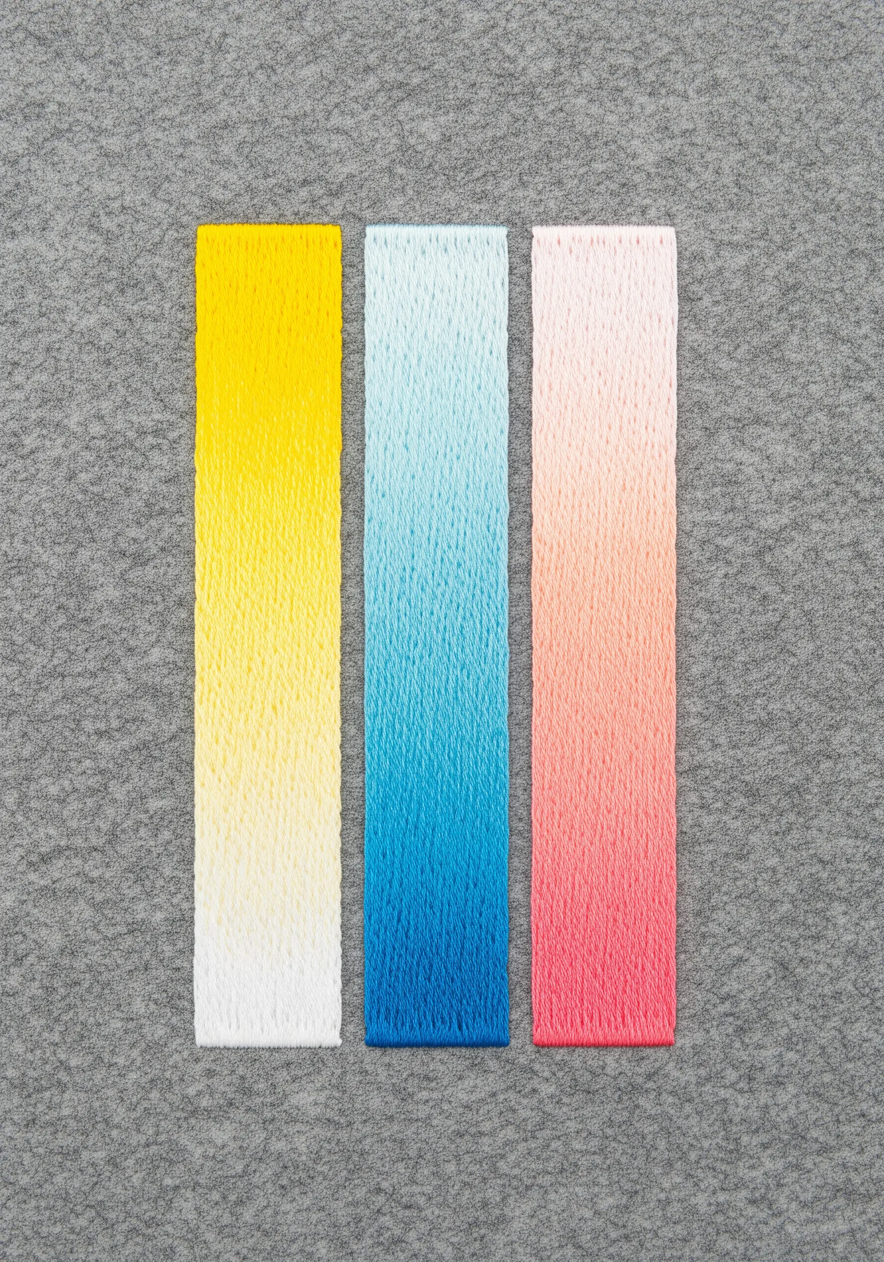 Three vertical bars of perfectly blended satin stitch in yellow, blue, and pink.