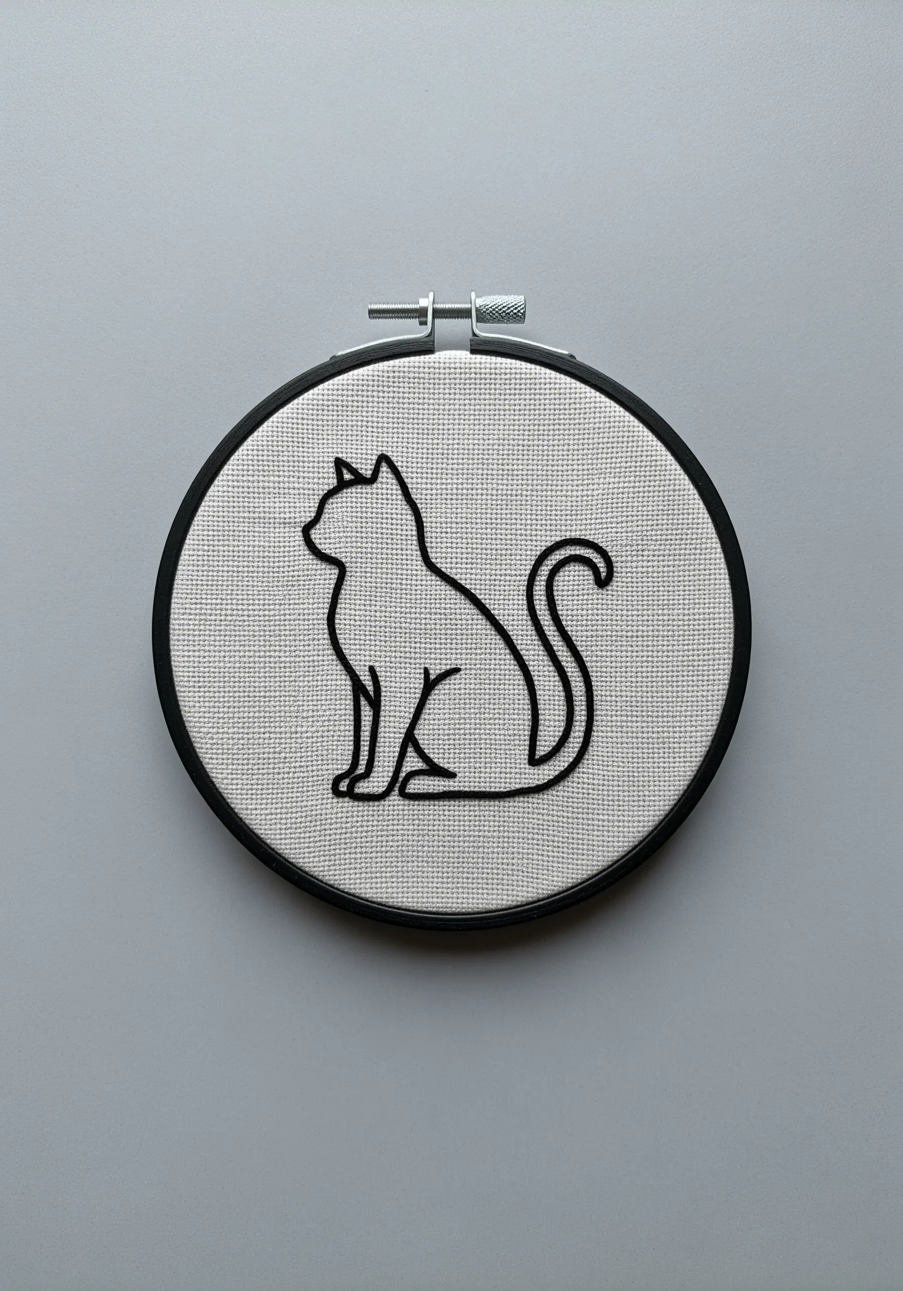 A smooth, continuous black outline of a sitting cat silhouette.