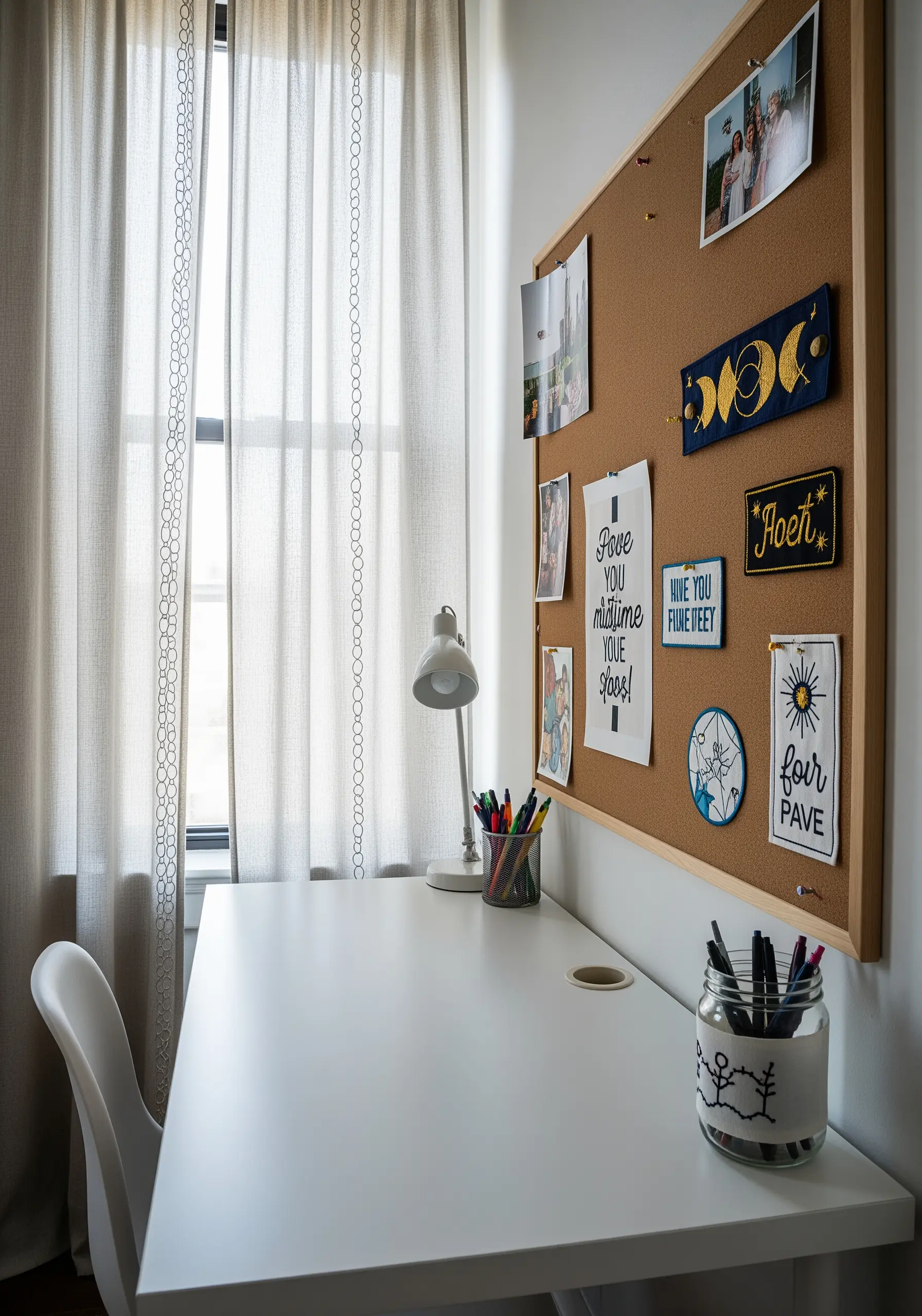 Embroidered patches with celestial motifs and quotes pinned to a corkboard above a desk.
