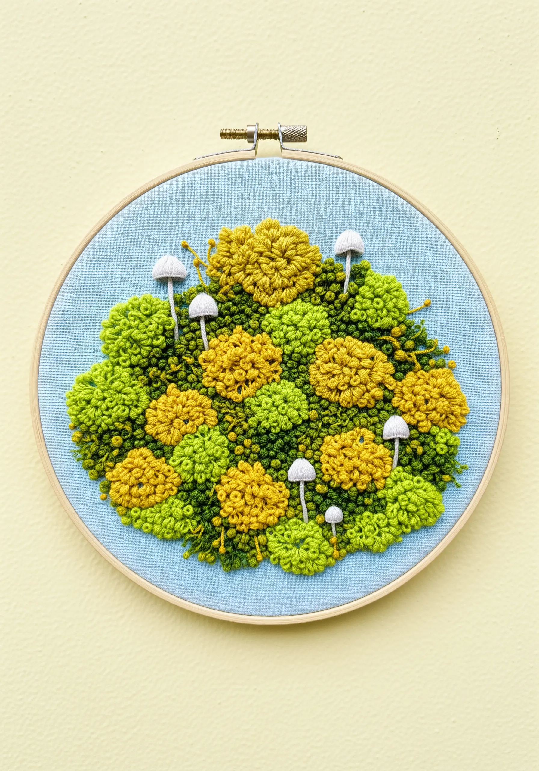 Fluffy yellow and green moss made of French knots with tiny white mushrooms.