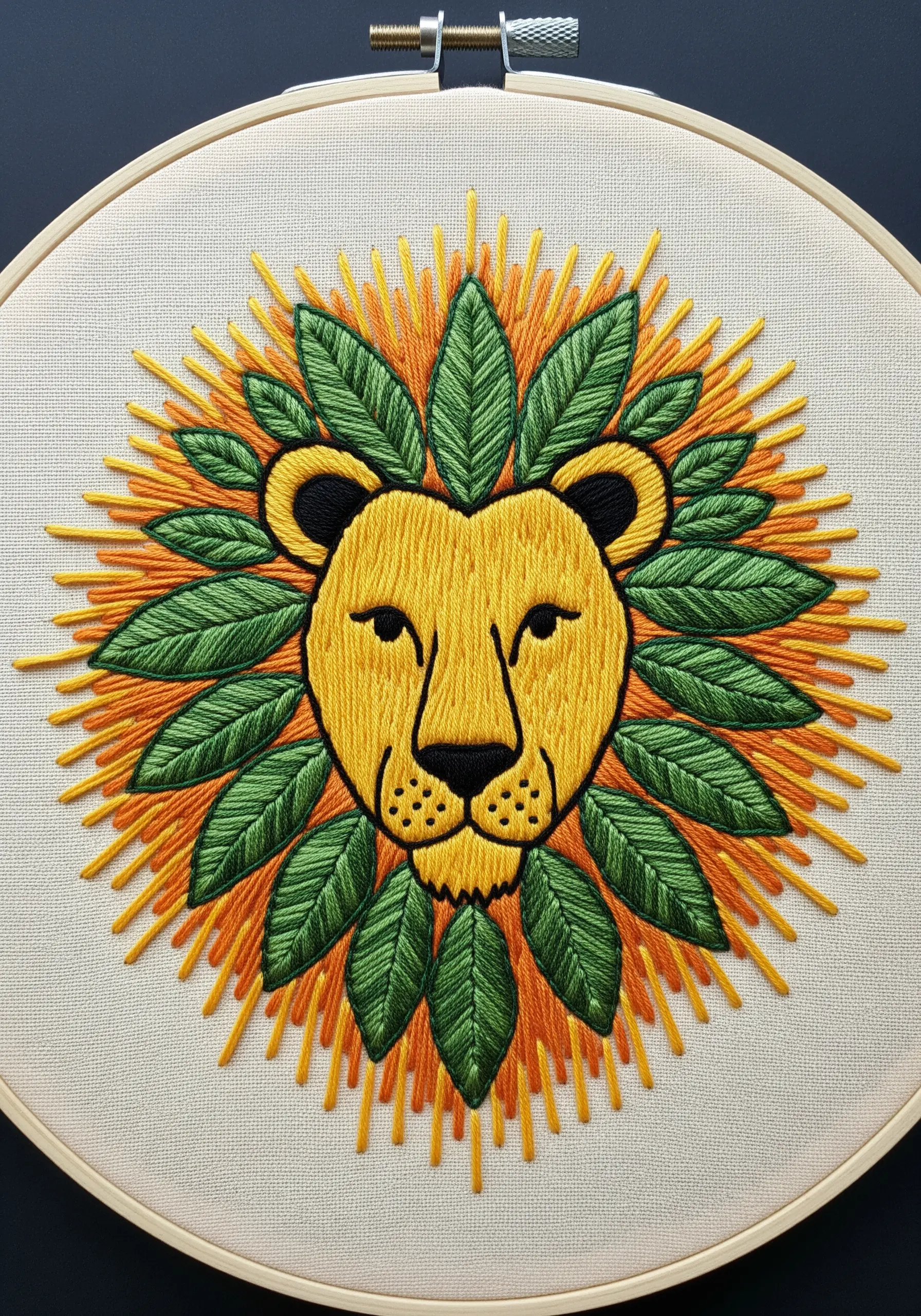 A stylized lion face with a mane made of radiating straight stitches and green leaves.