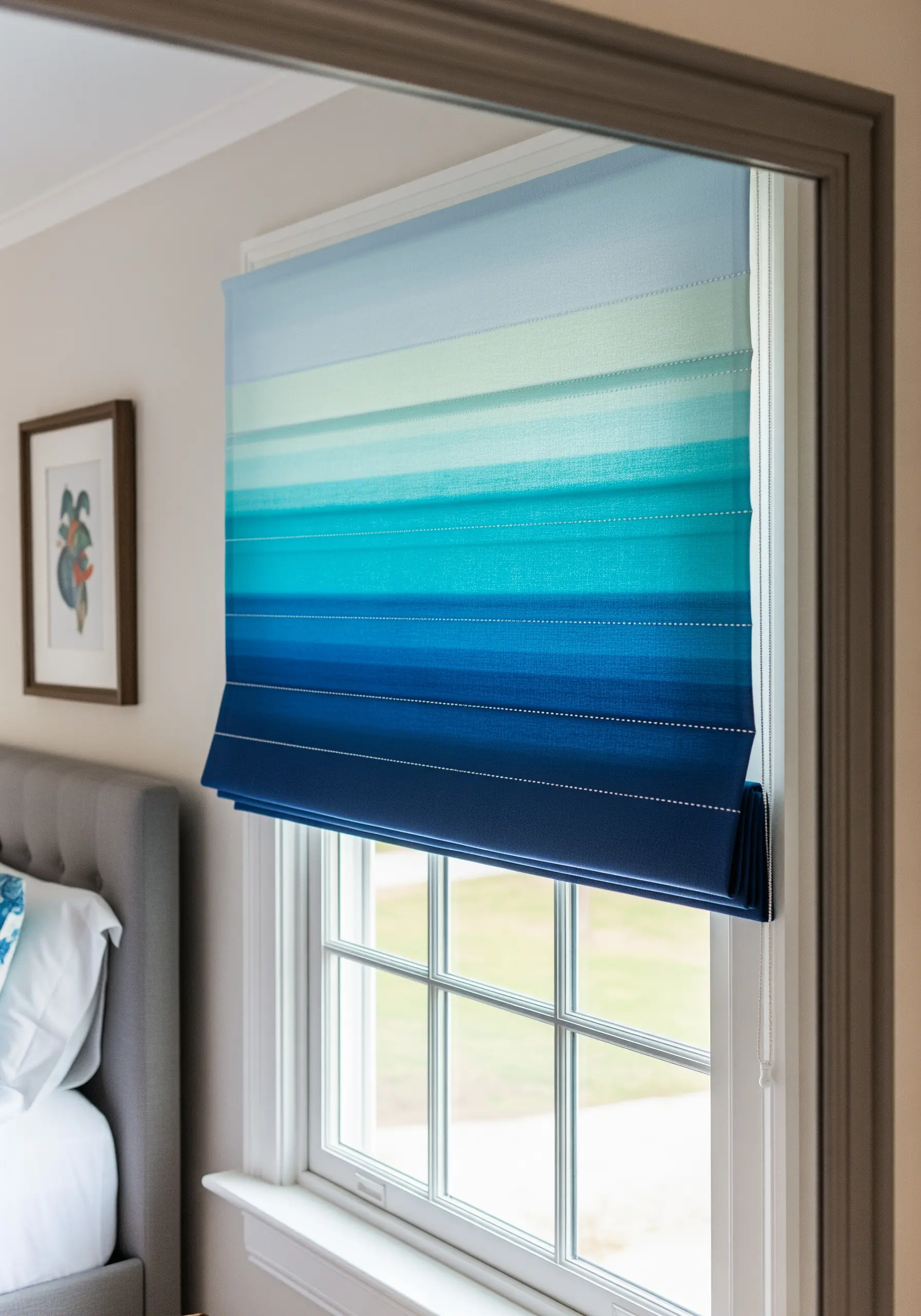A Roman window blind with a horizontal ombré pattern from dark blue to light aqua.