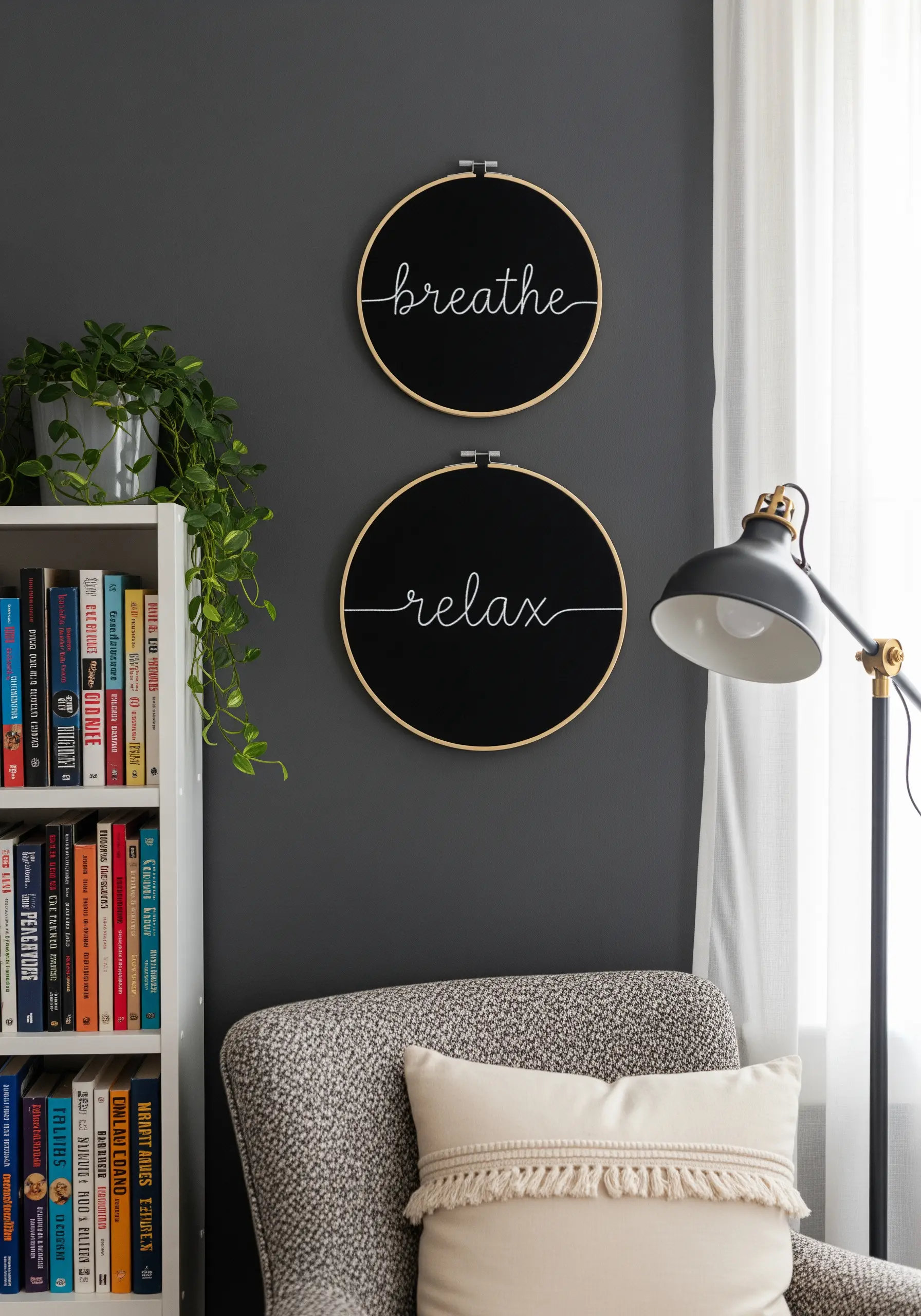 Two hoops with the words 'breathe' and 'relax' embroidered in white script on black fabric.