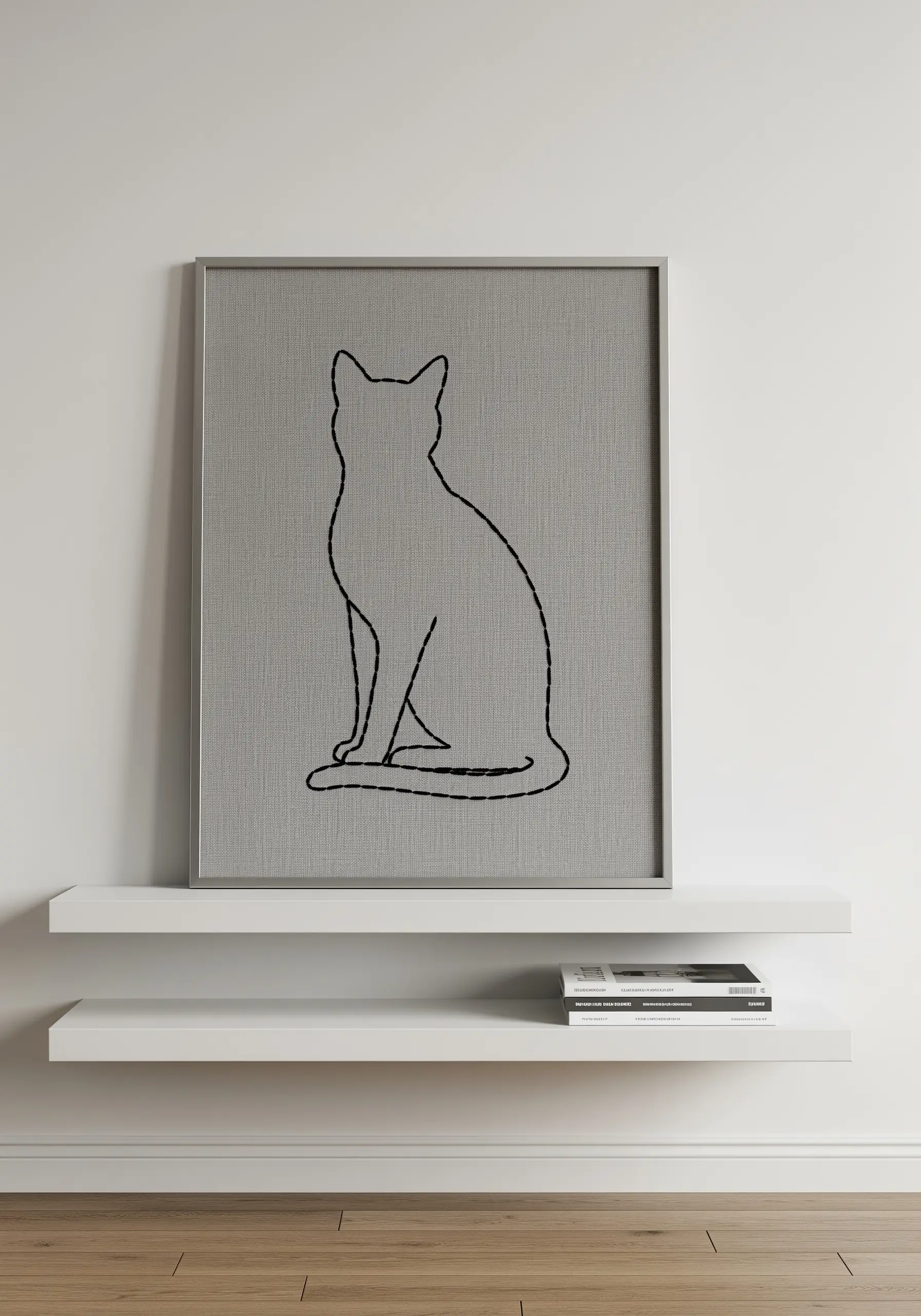 A minimalist cat silhouette embroidered in black split stitch on gray linen.