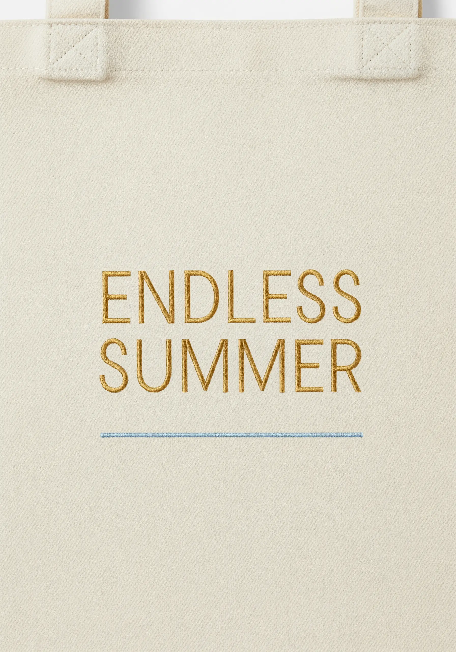 The words 'Endless Summer' embroidered in a clean, gold-colored font on a canvas tote.