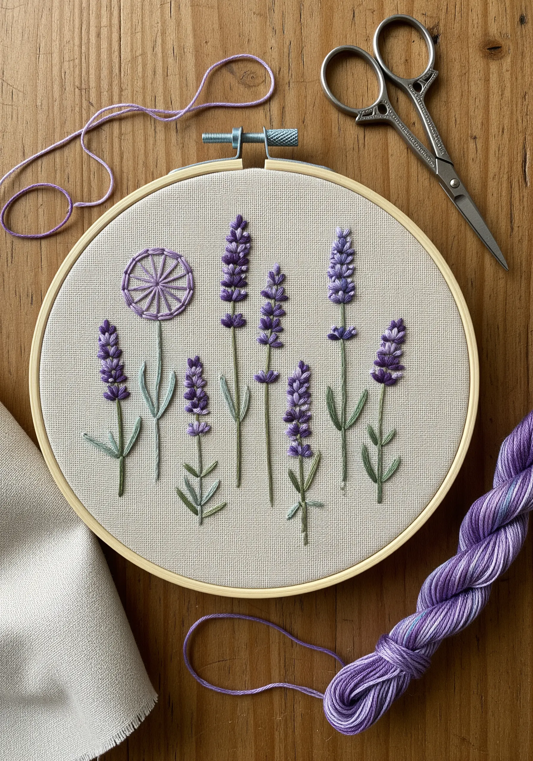 Hand-embroidered lavender stems with purple French knots and a wheel stitch on neutral fabric.
