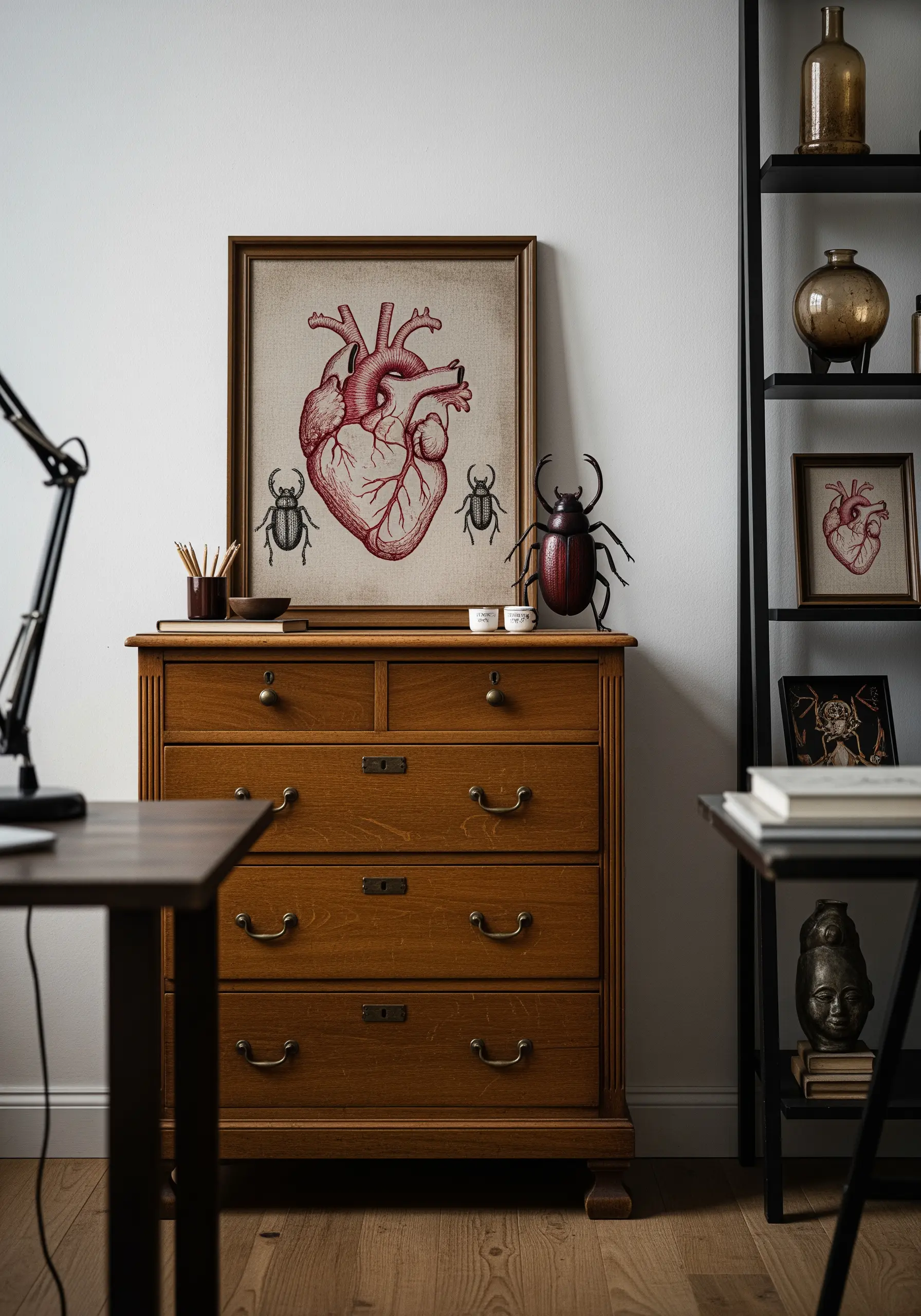 A framed embroidery of a red anatomical heart, styled like a vintage scientific illustration.