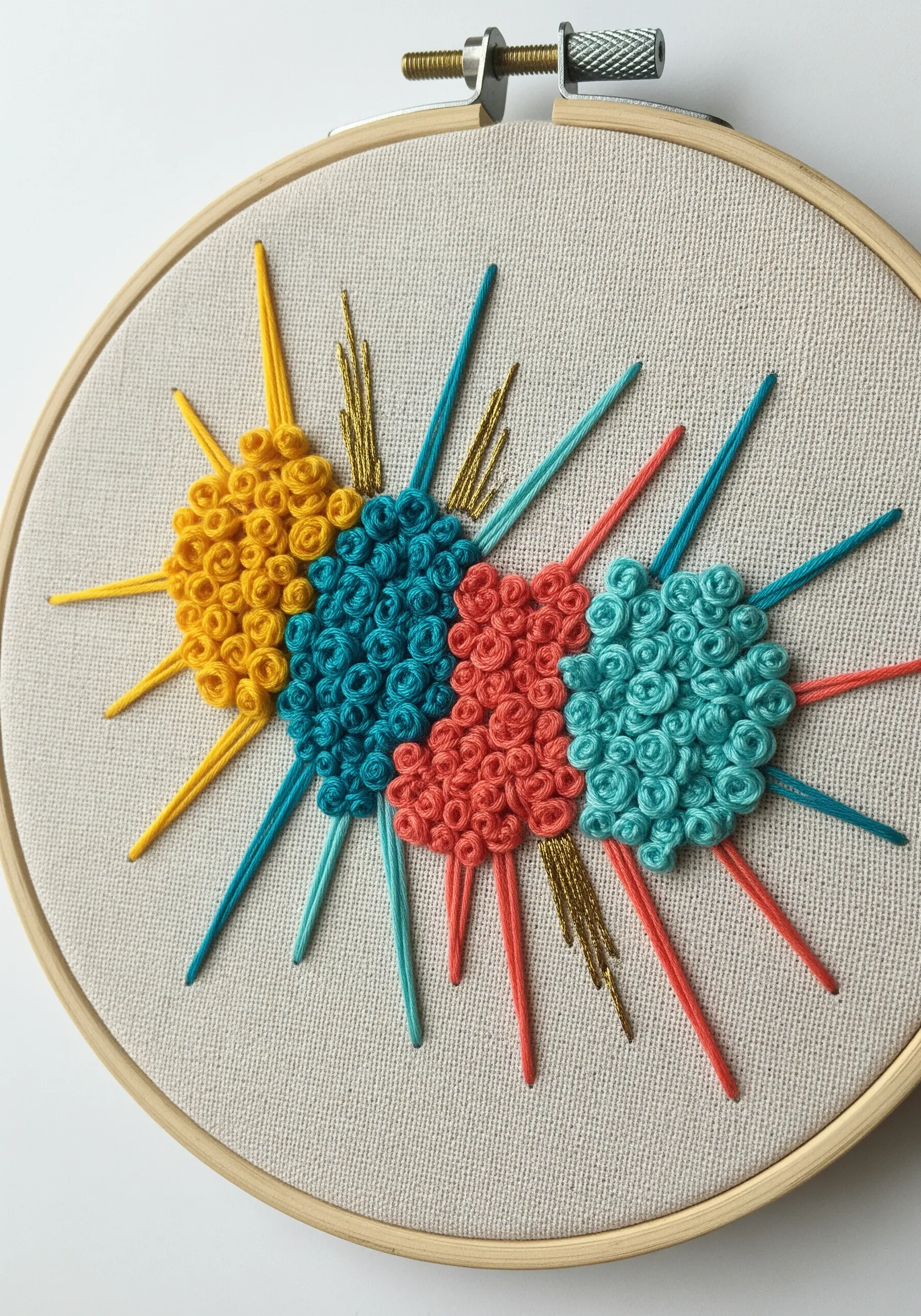 Colorful starburst motifs made from clustered French knots and straight stitches.