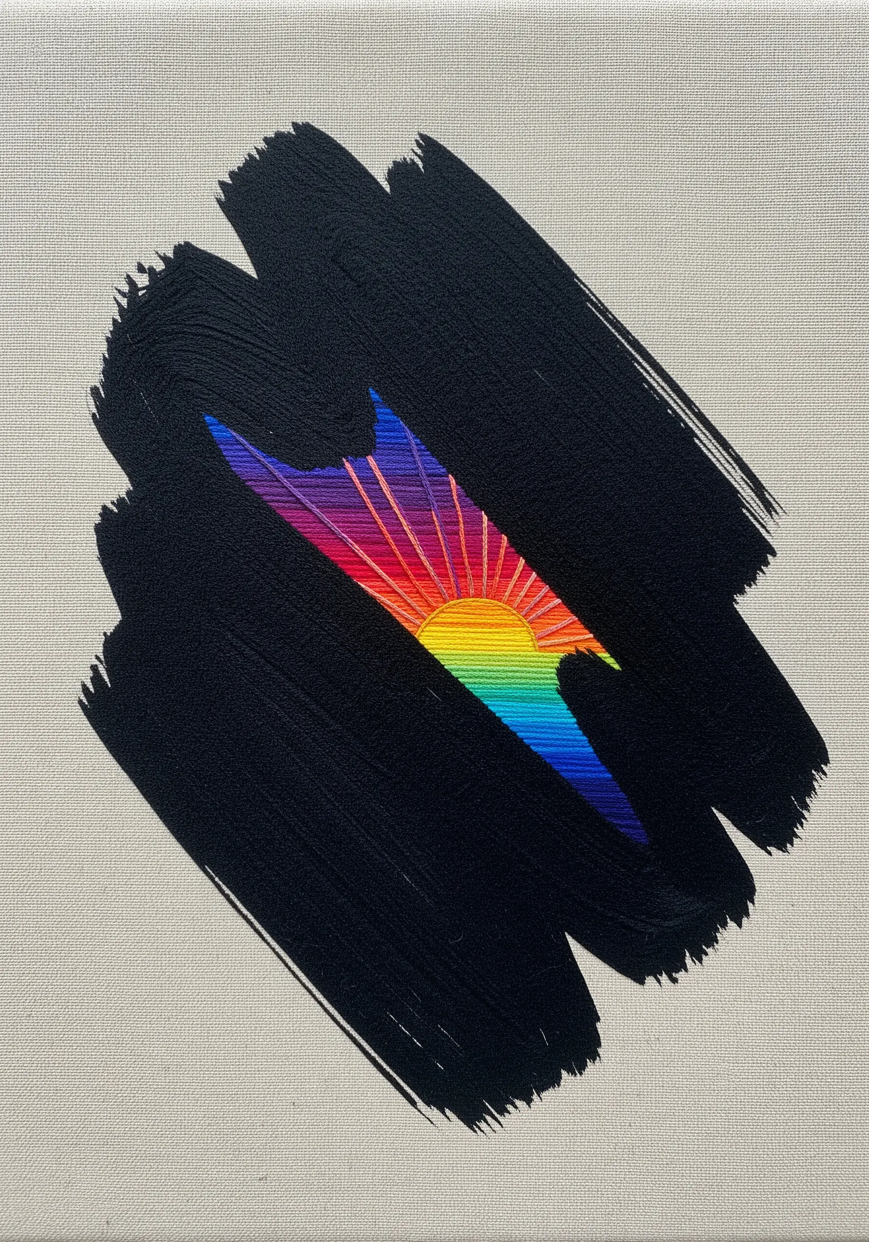 A black painted brushstroke on canvas with a vibrant, embroidered rainbow sunrise revealed within.