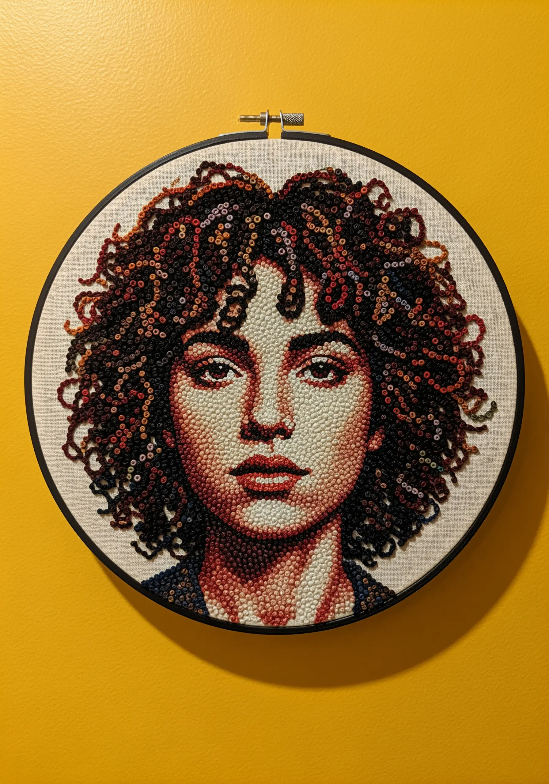 A portrait with voluminous curly hair created with a dense texture of multi-colored French knots.