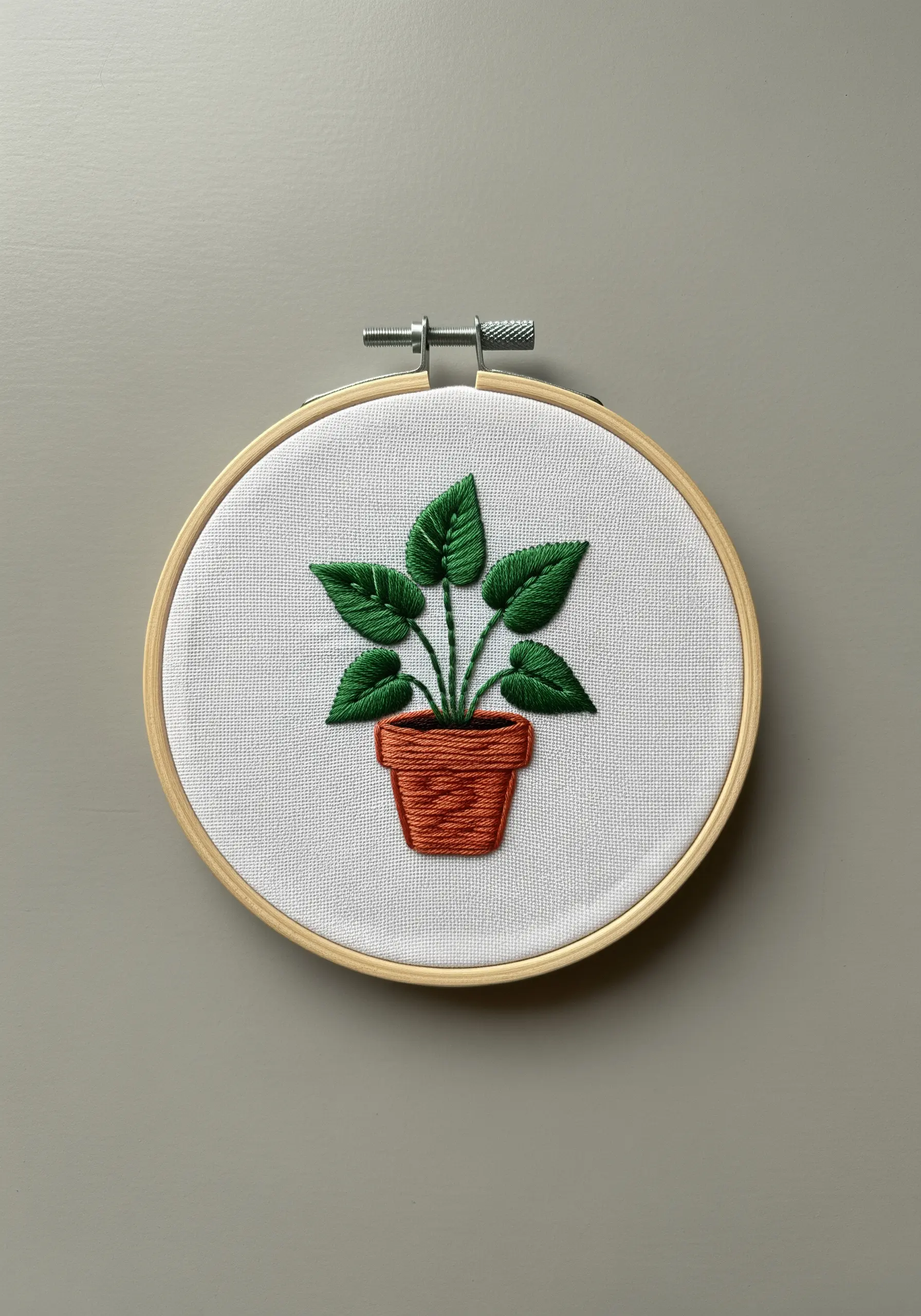 A potted houseplant with satin-stitched leaves angled in different directions for dimension.