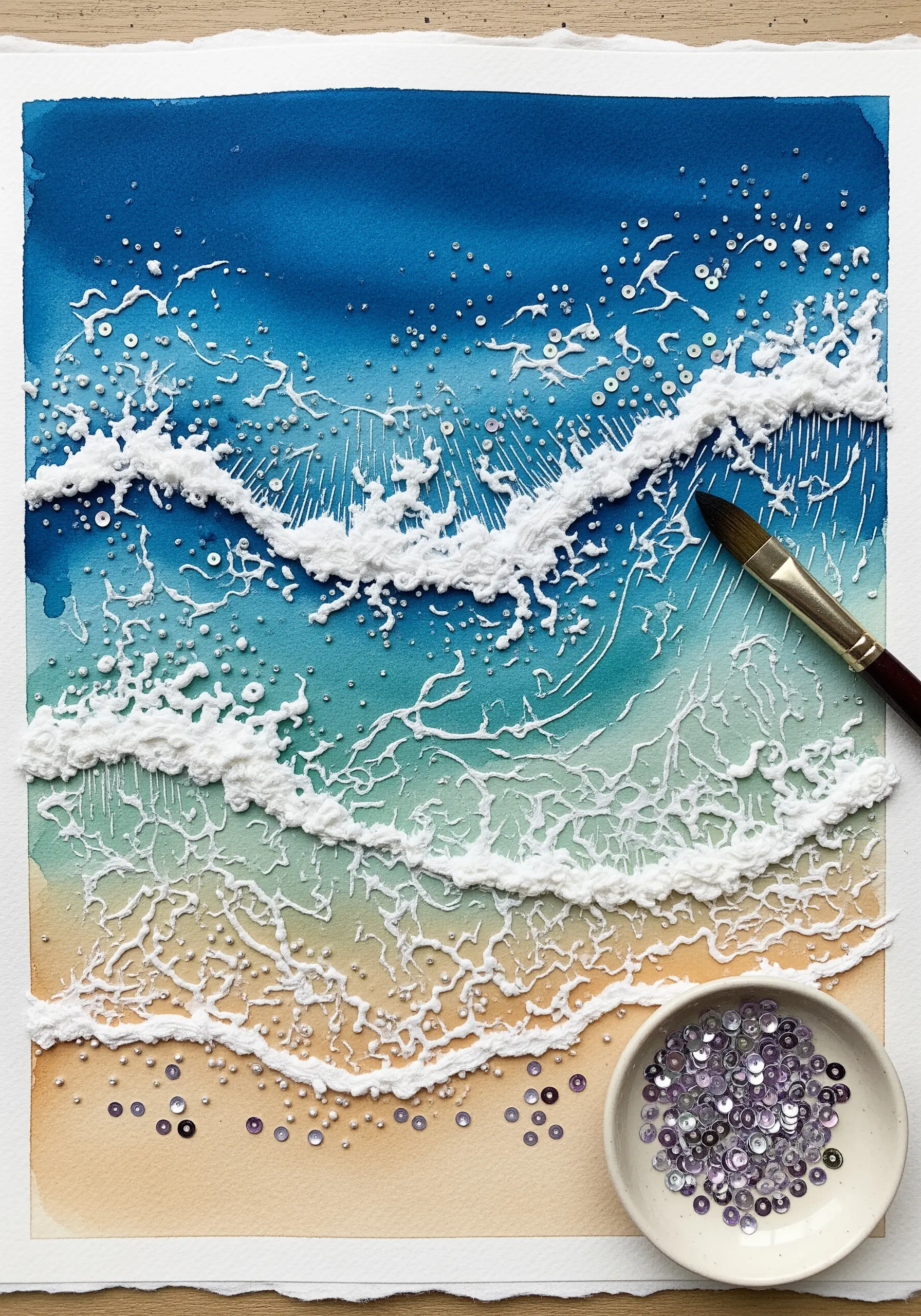 Textured white embroidery creating sea foam on a watercolor ocean painting.
