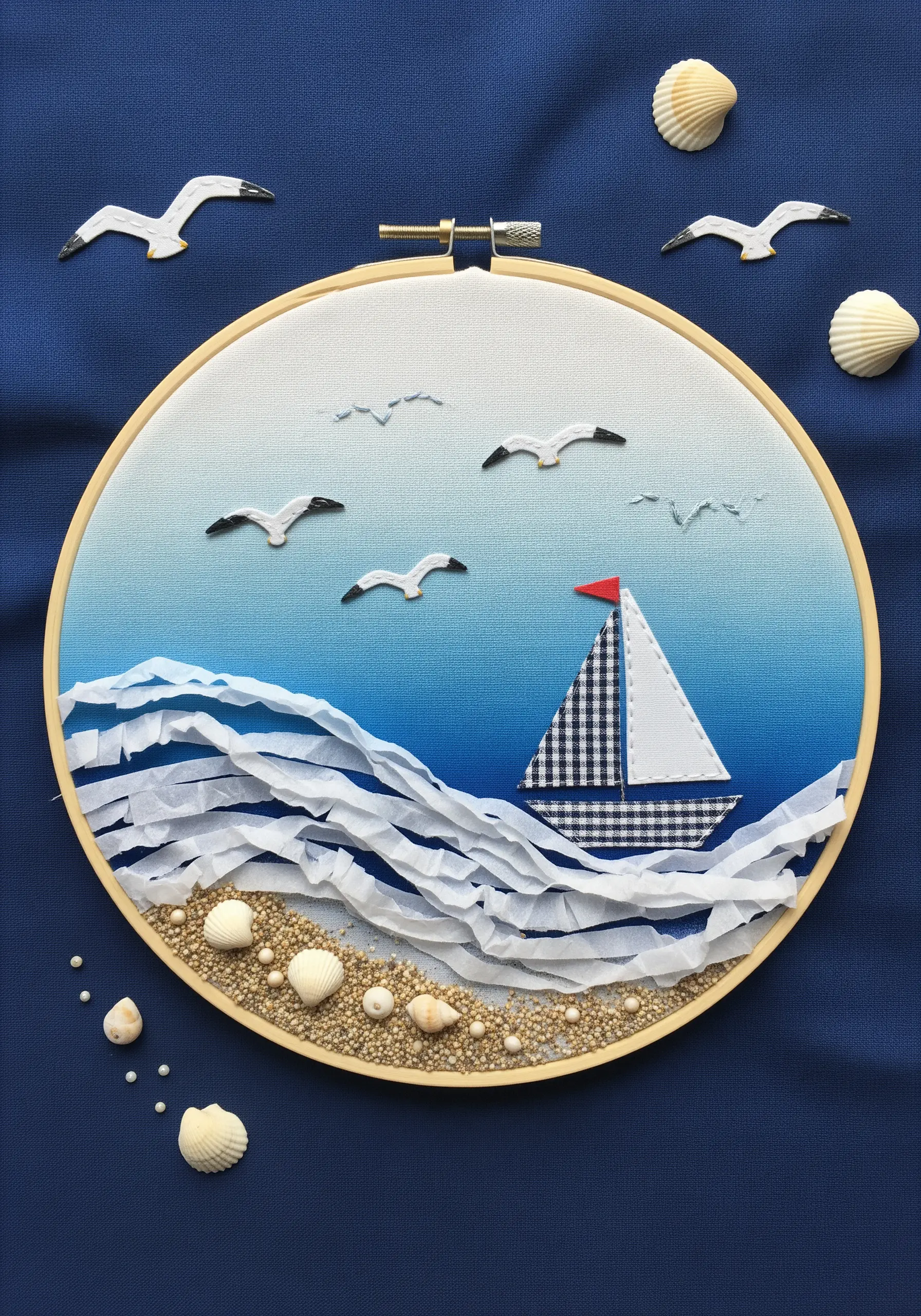 Hoop art seascape with ruched white fabric waves, a gingham boat, and a sandy shore