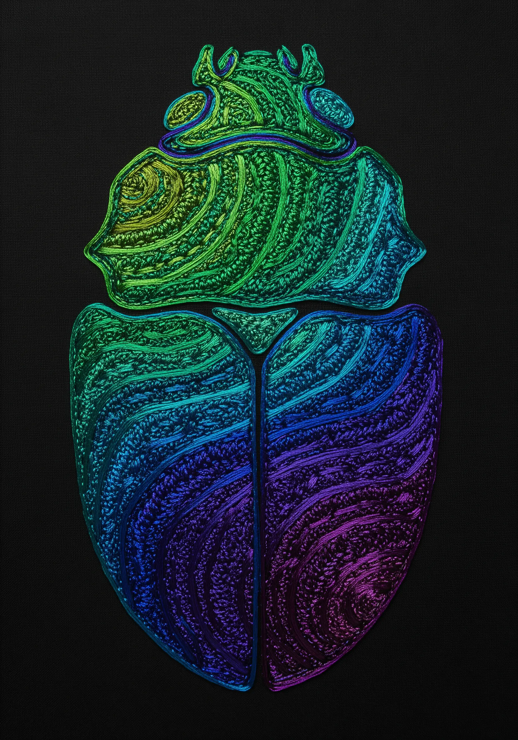 An embroidered beetle with intricate, swirling stitches in a rainbow gradient on black fabric.