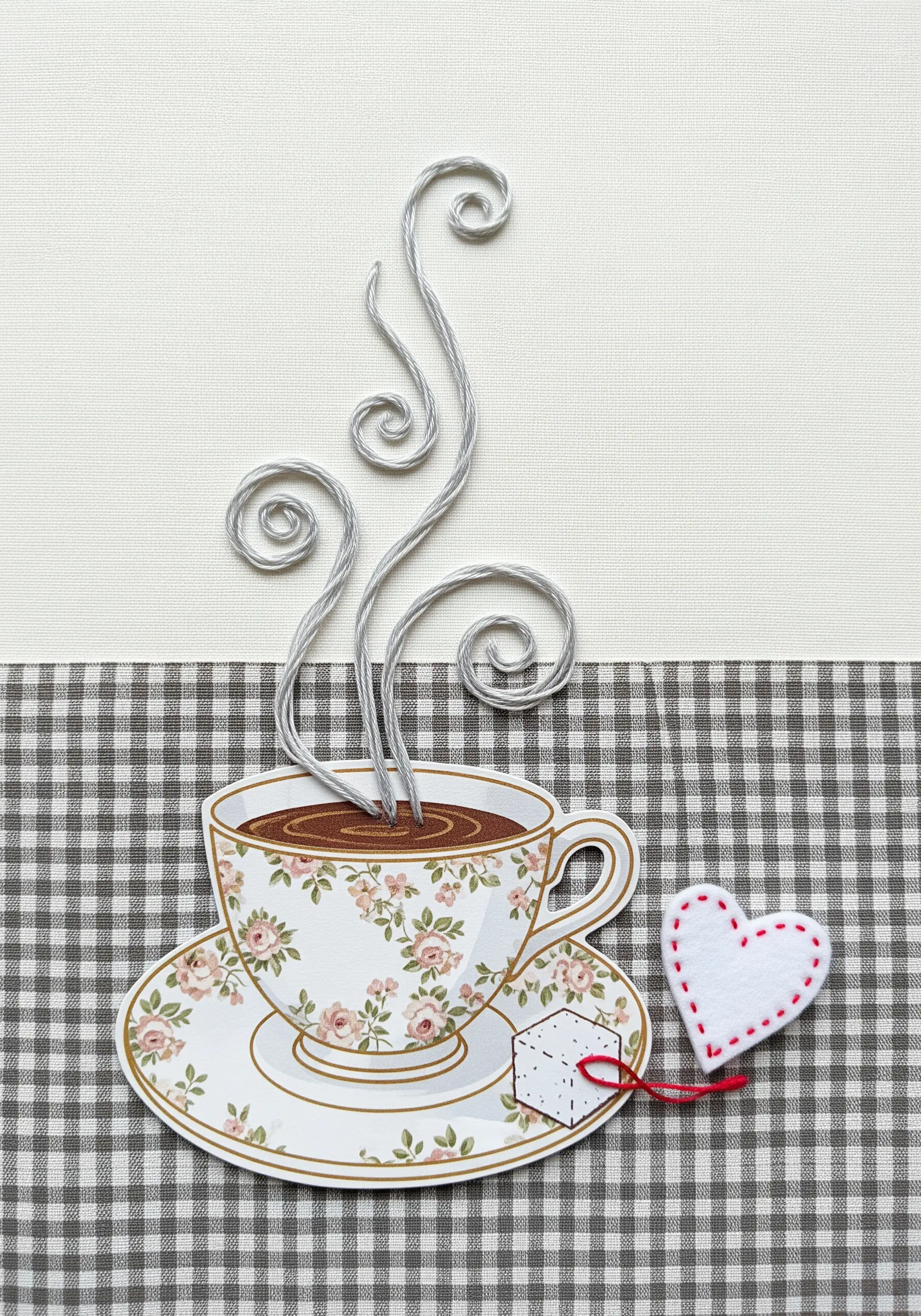 A paper teacup collage with 3D steam made from thread wrapped around bent wire