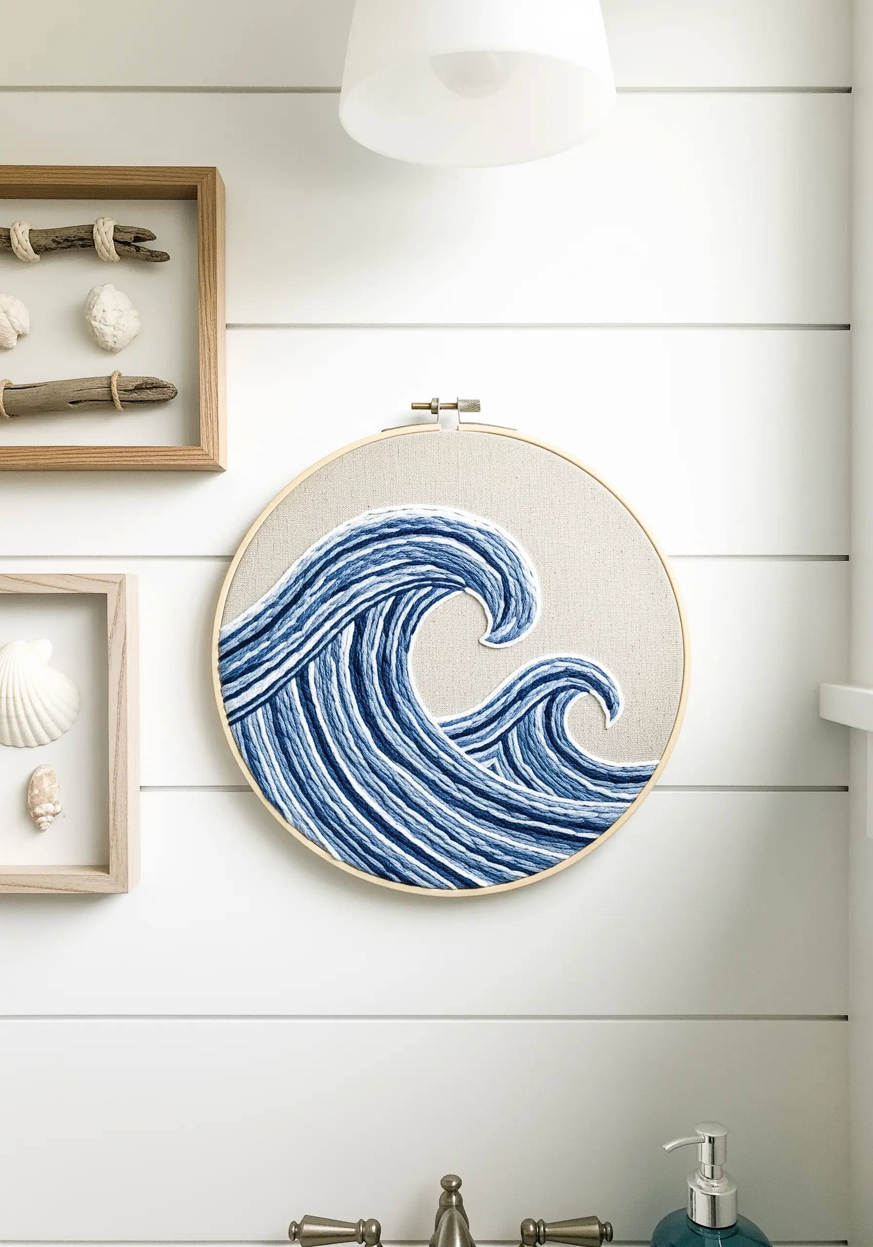 Stylized ocean waves in shades of blue and white, created with directional long stitches.