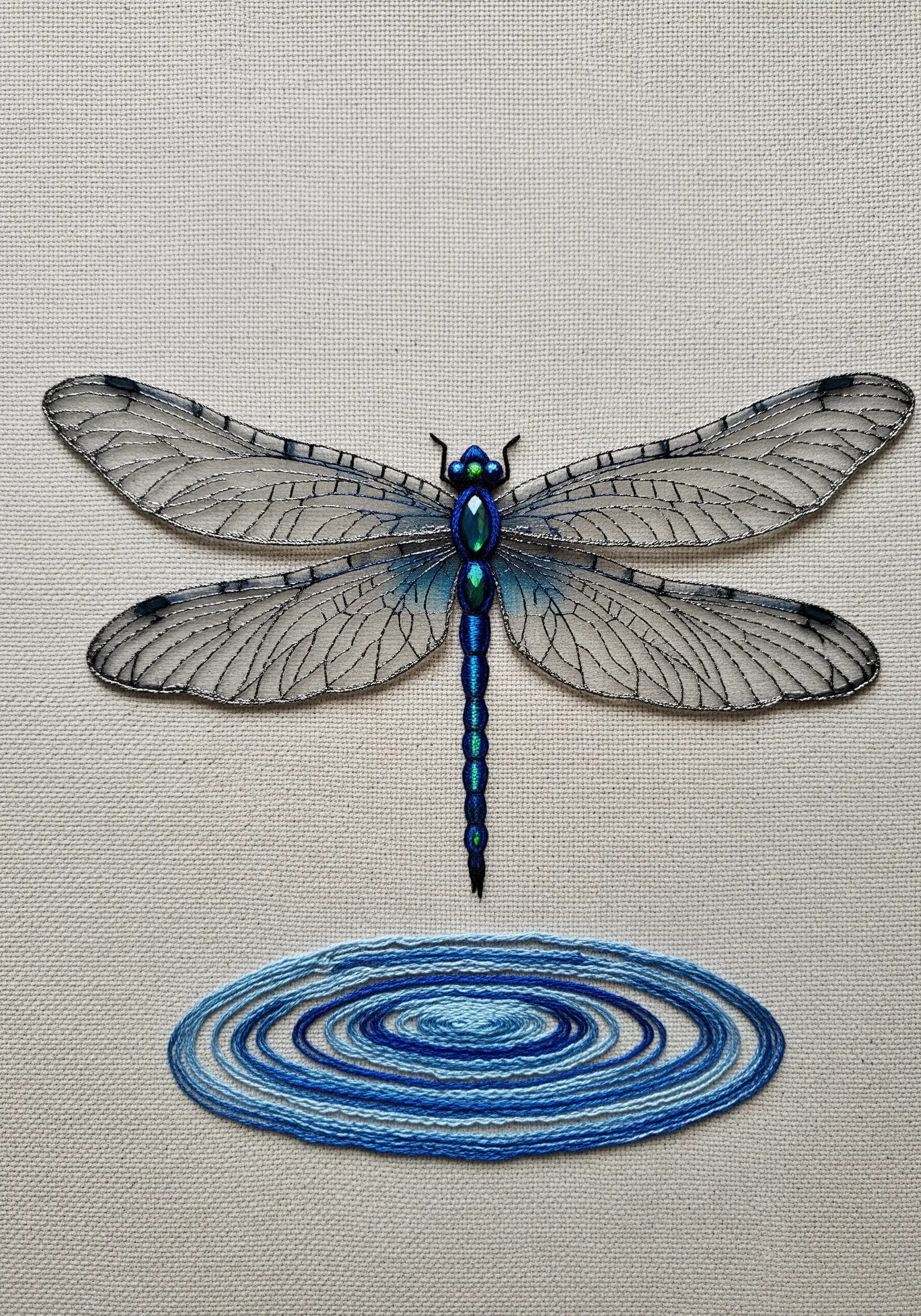 Translucent dragonfly wings embroidered with silver metallic outline stitches.