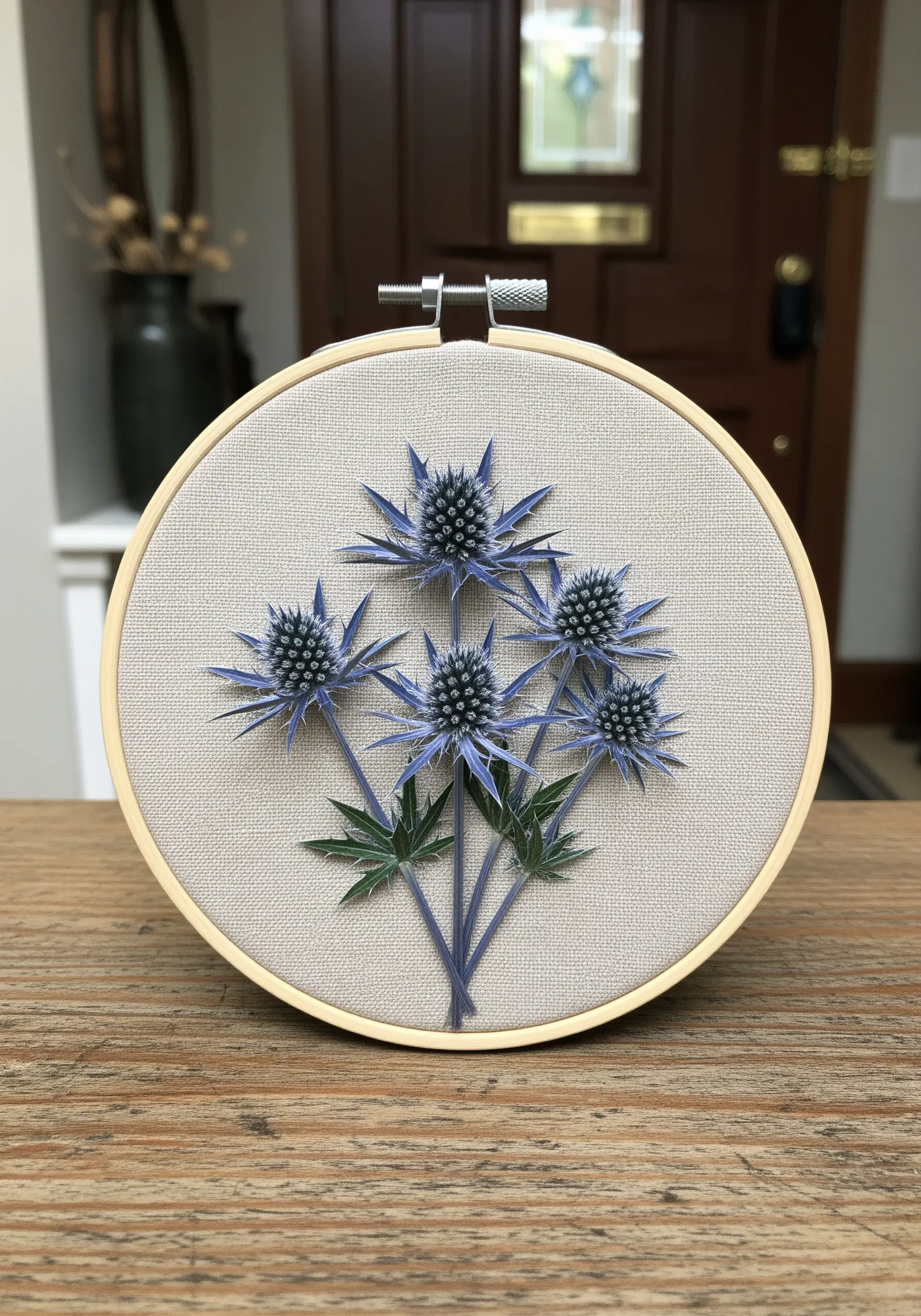 Real pressed sea holly flowers combined with embroidered stems in a hoop