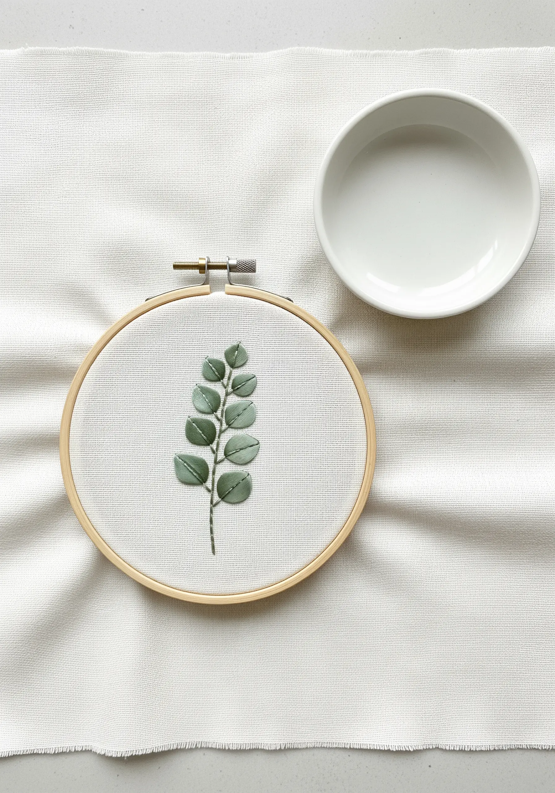 A single branch with green silk ribbon leaves and a thread stem.