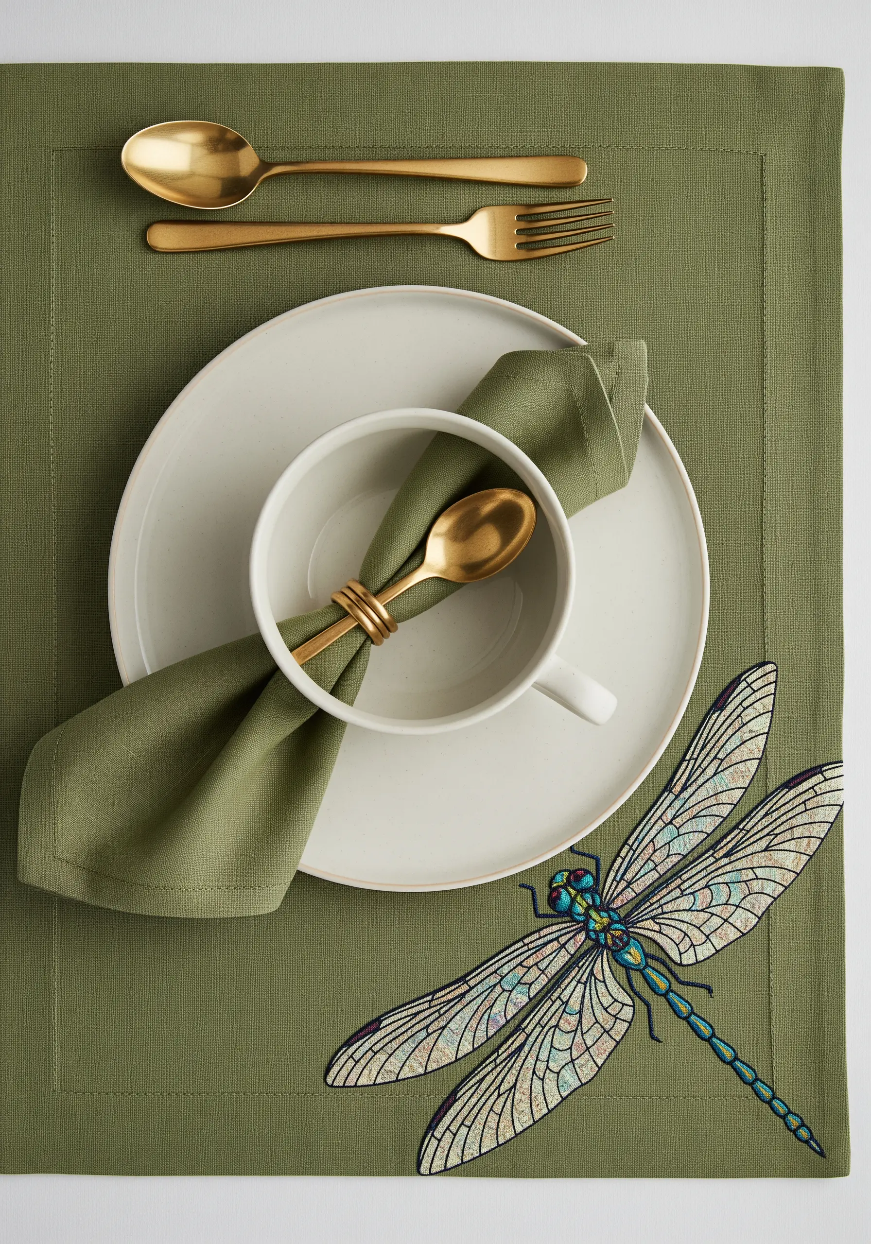 A large, detailed dragonfly embroidered on an olive green placemat, resembling stained glass.
