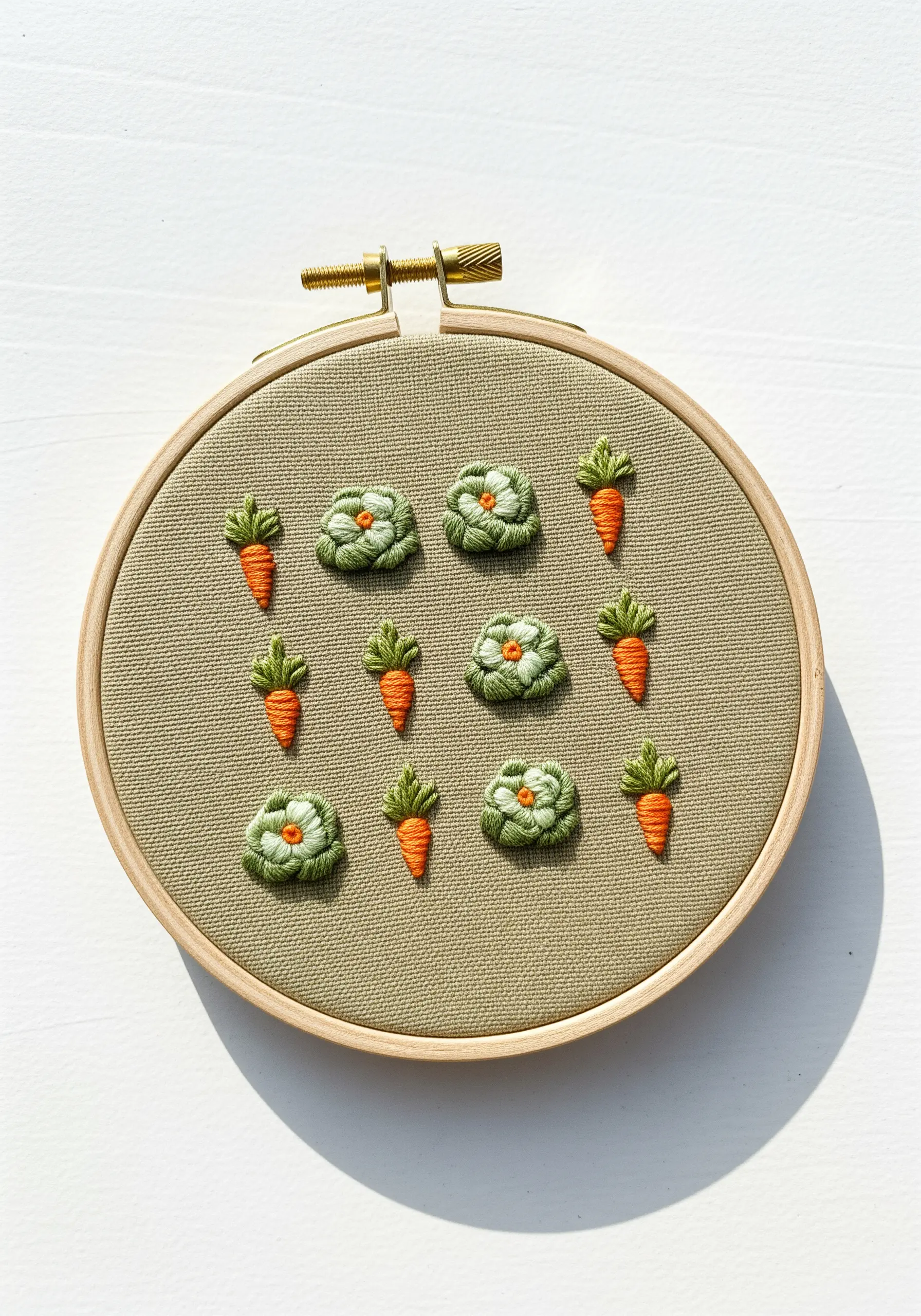 Embroidered vegetable patch with 3D woven wheel cabbages and satin stitch carrots.