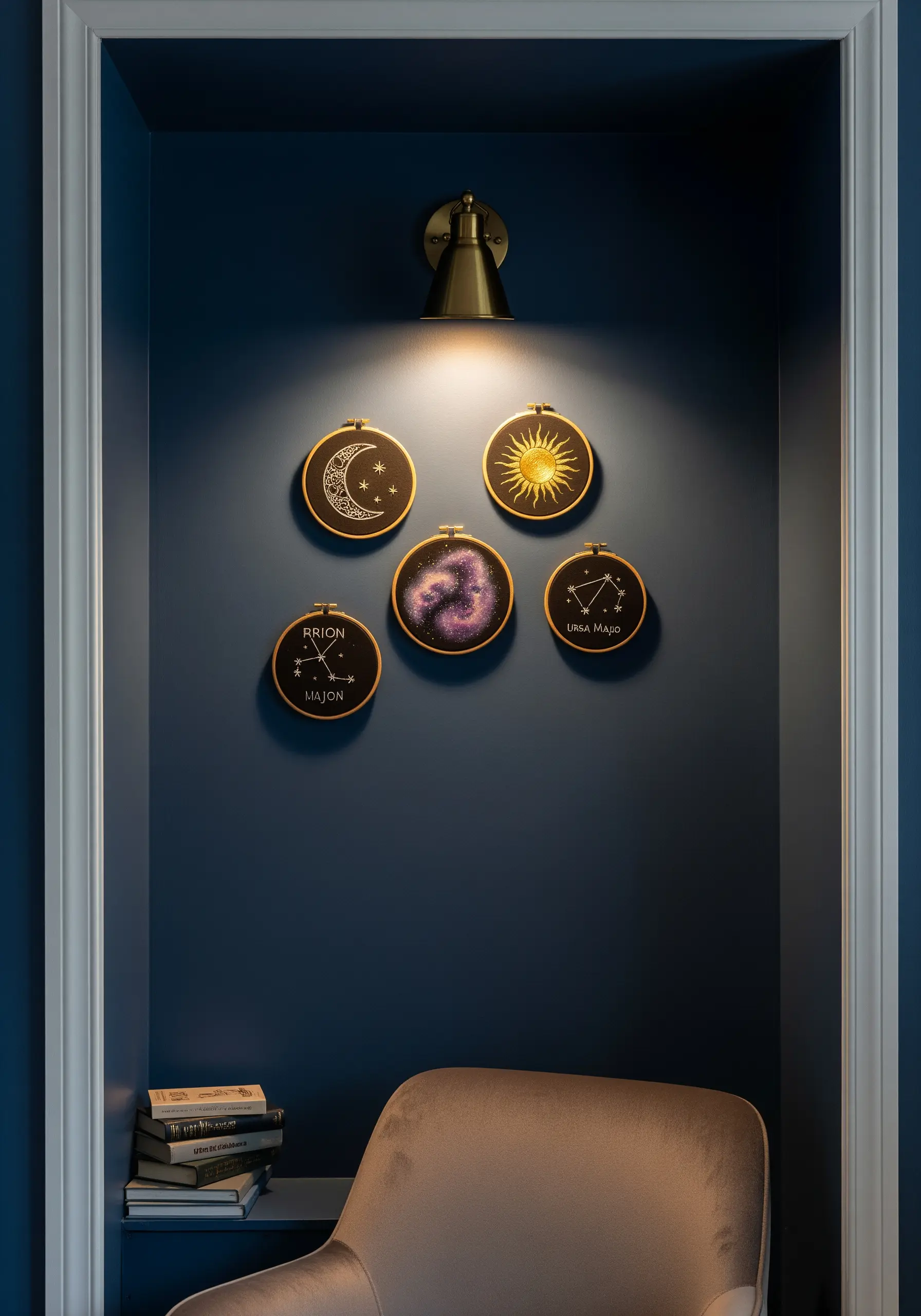 Five celestial-themed embroidery hoops, including constellations and a nebula, in a dark blue nook.