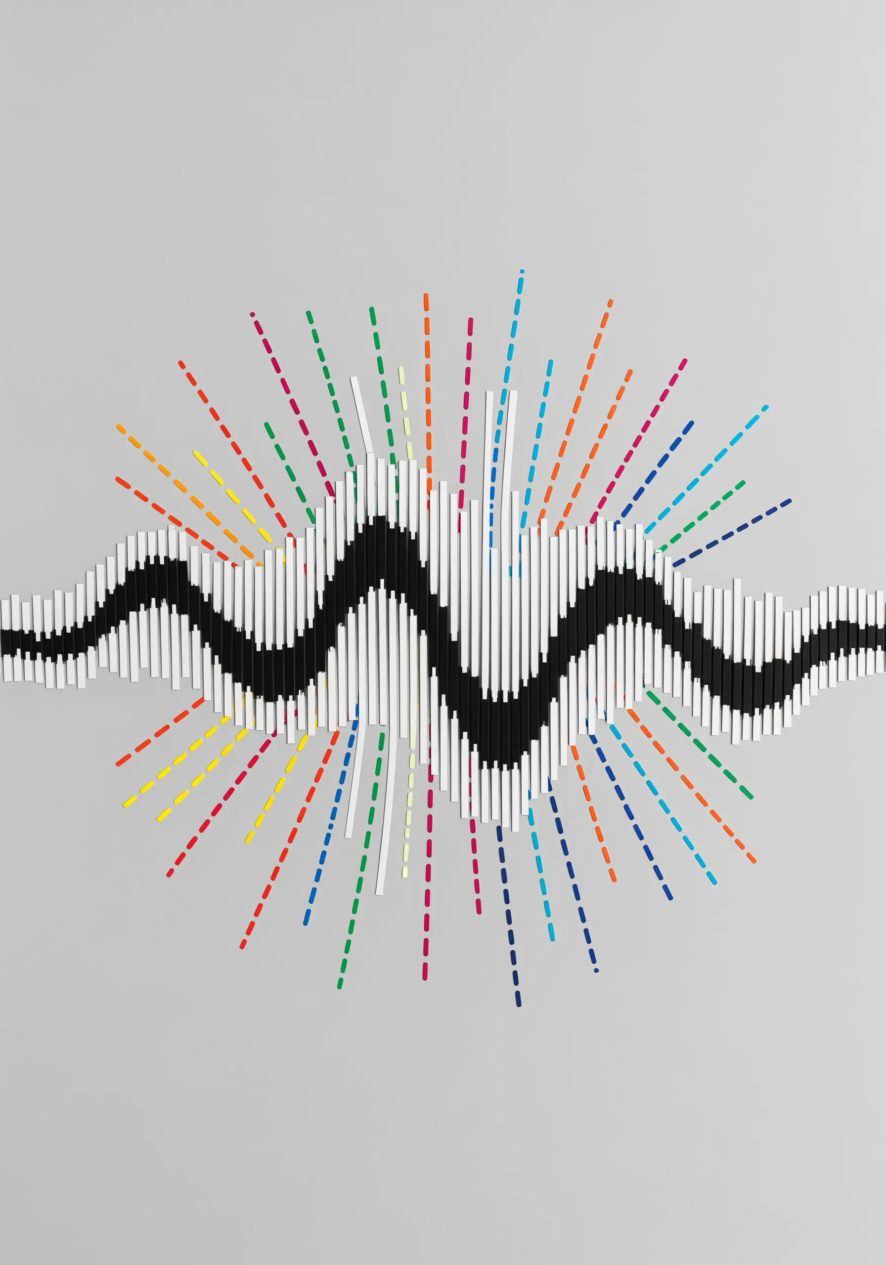A 3D paper sculpture of a sound wave with colorful radiating lines.