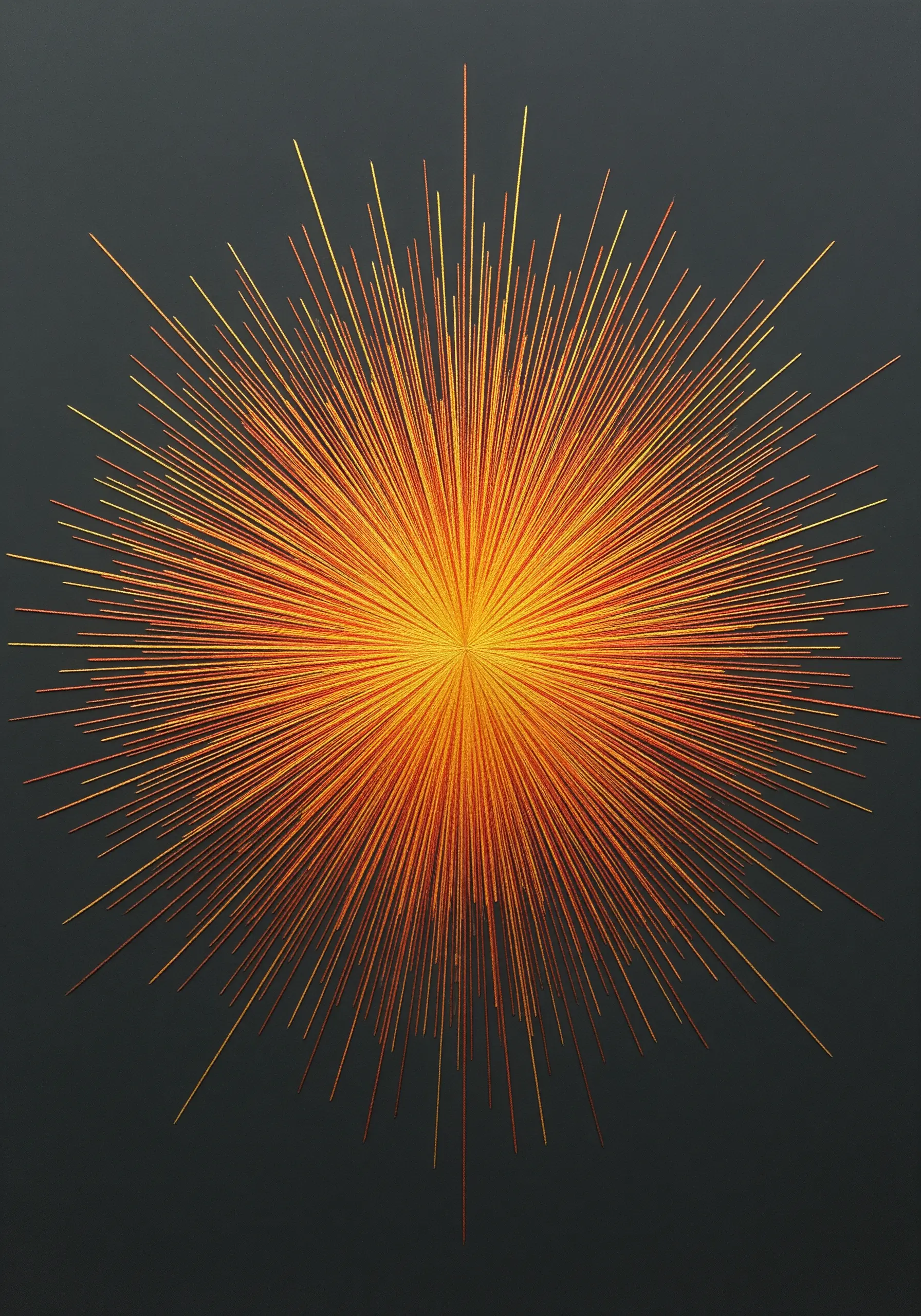 A starburst design stitched with radiating lines of yellow, orange, and red metallic thread.