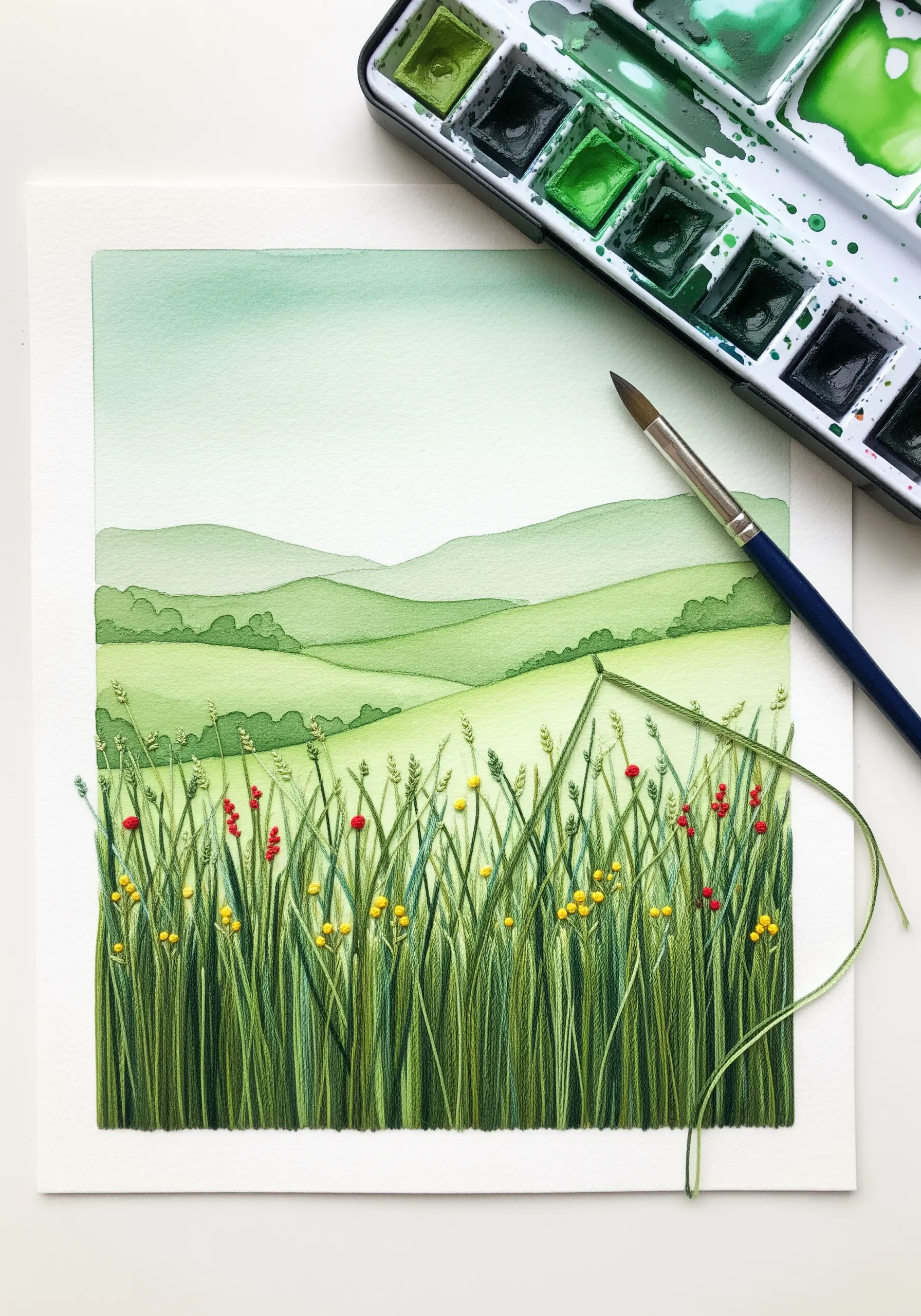 A watercolor landscape with a densely stitched foreground of green grasses and wildflowers.