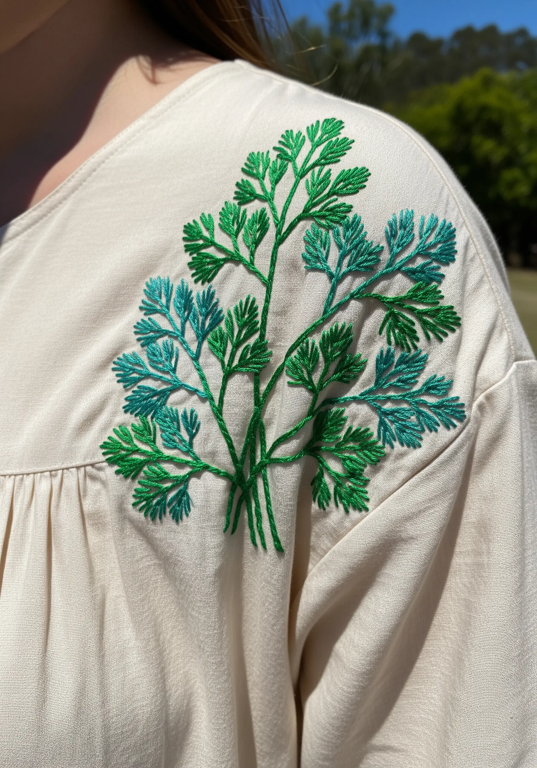A light and airy bouquet of cilantro or parsley embroidered on a dress shoulder.