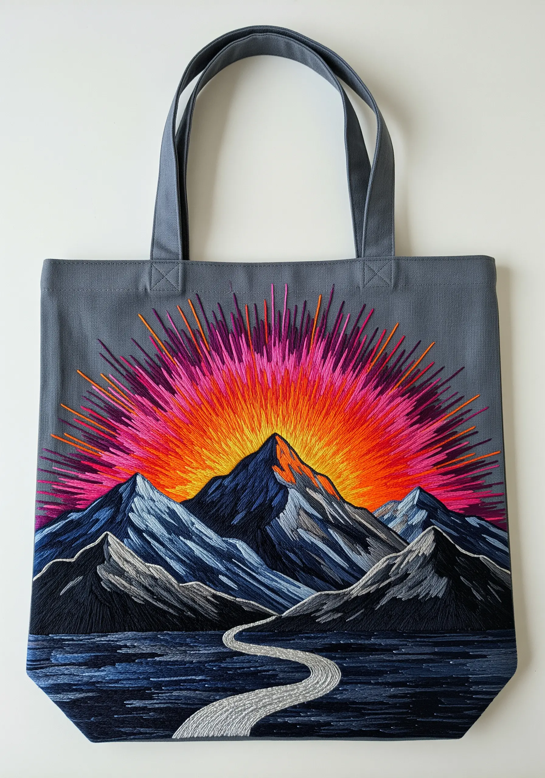 Vibrant mountain sunrise with an explosive, colorful sunburst on a gray tote
