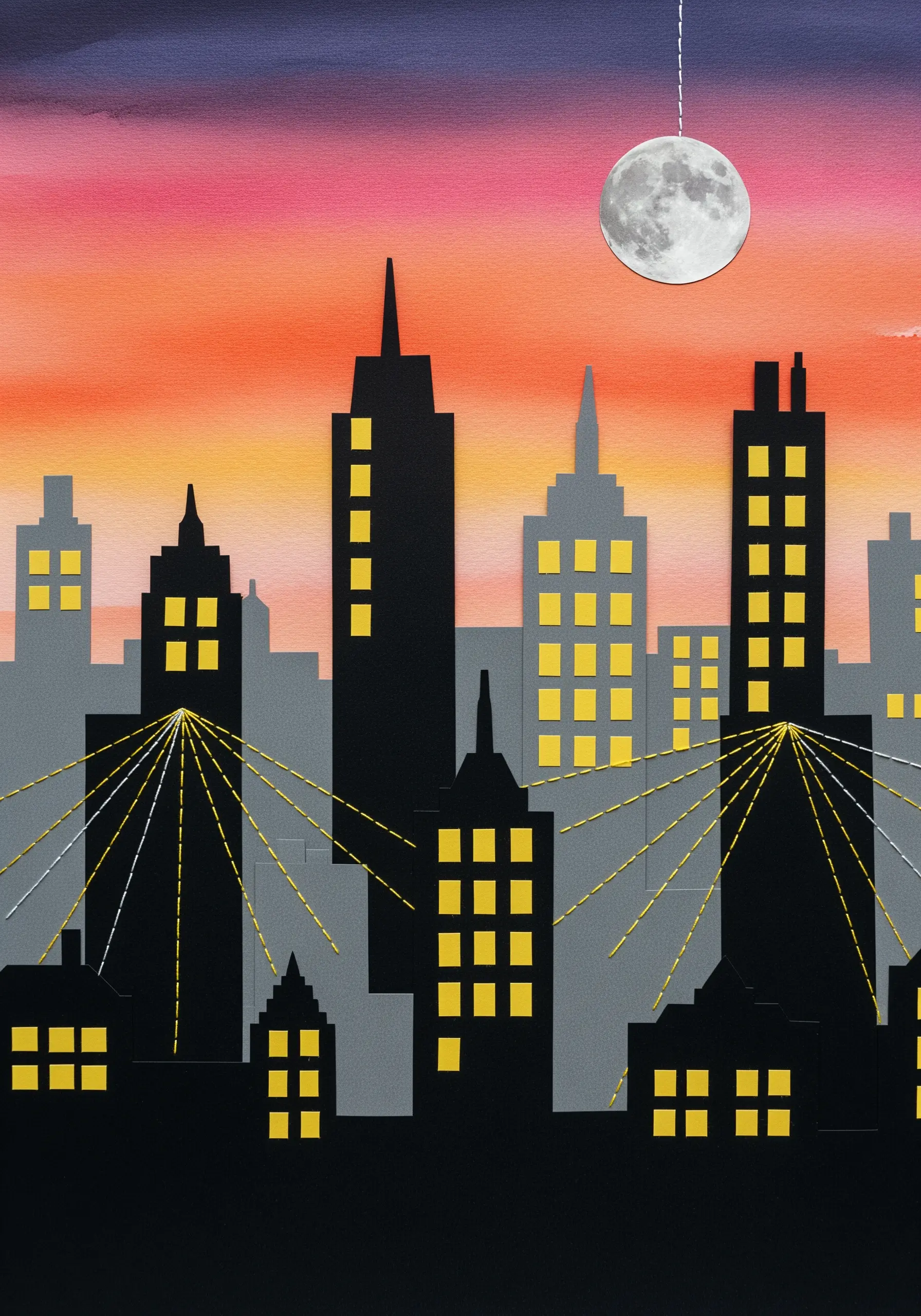 A paper collage cityscape at sunset with yellow thread stitched to look like light beams from windows.