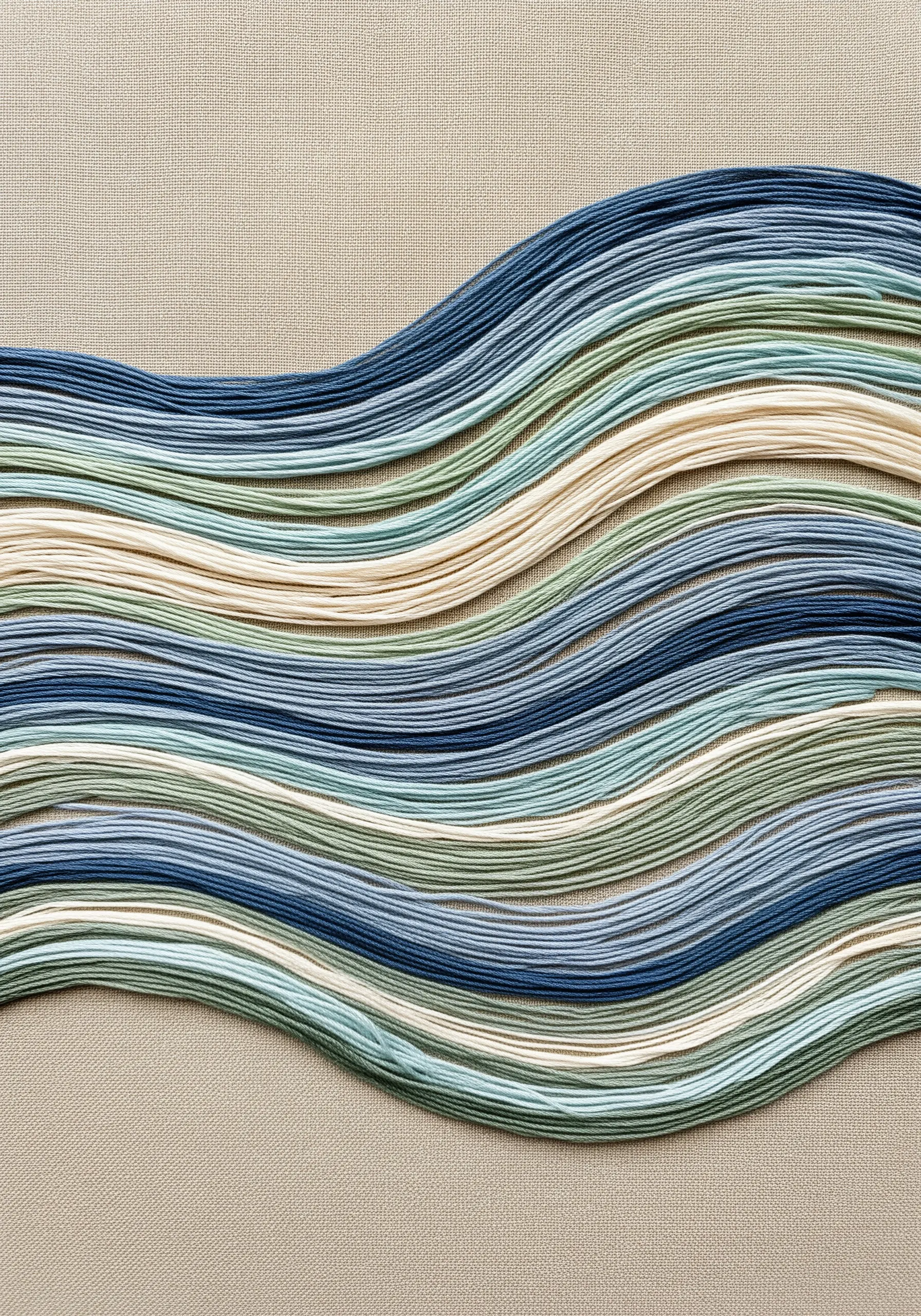 Dense, parallel, wavy lines of thread in blues, greens, and creams creating a wave pattern.