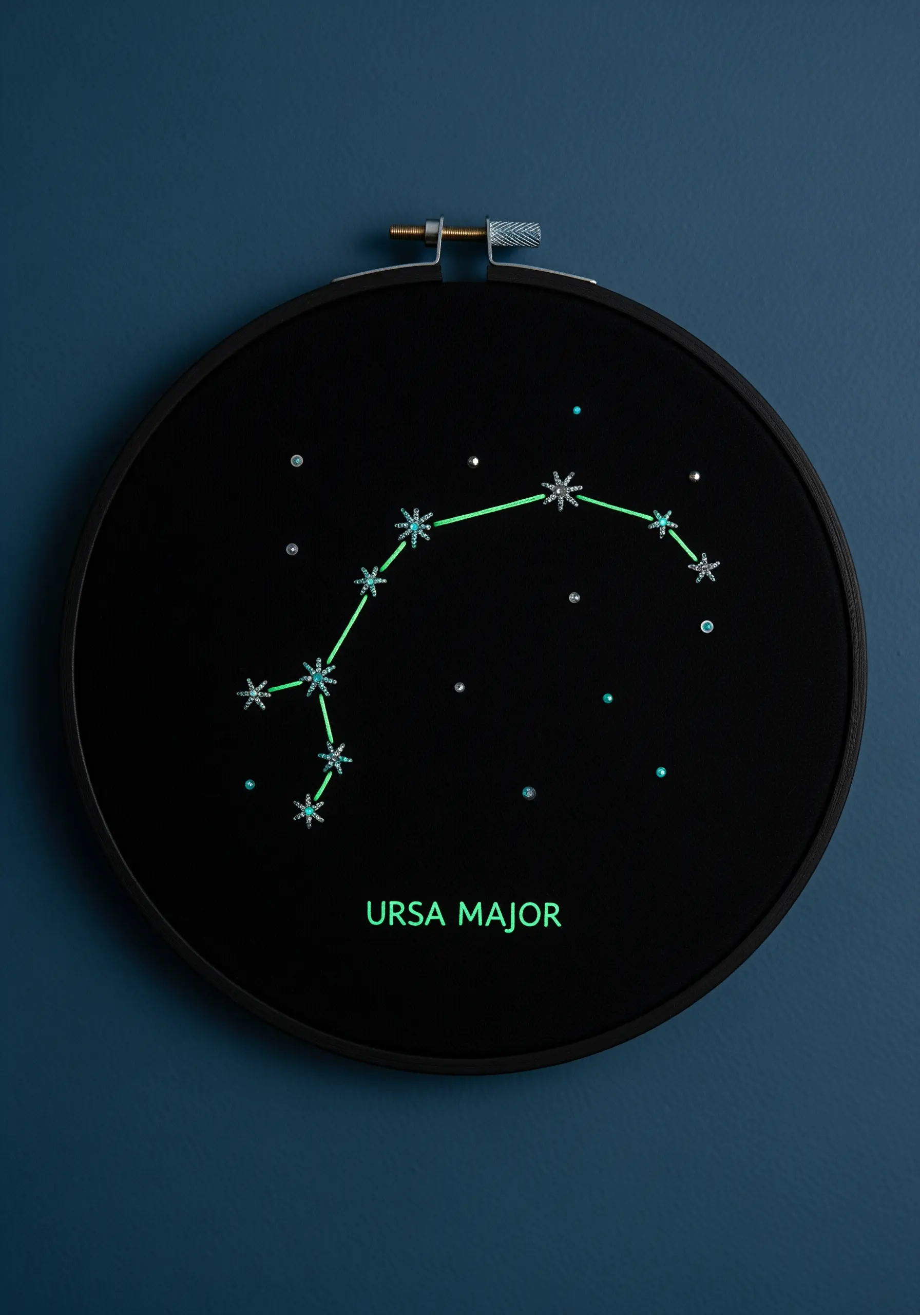 Ursa Major constellation stitched with glow-in-the-dark thread on black fabric in a black hoop.