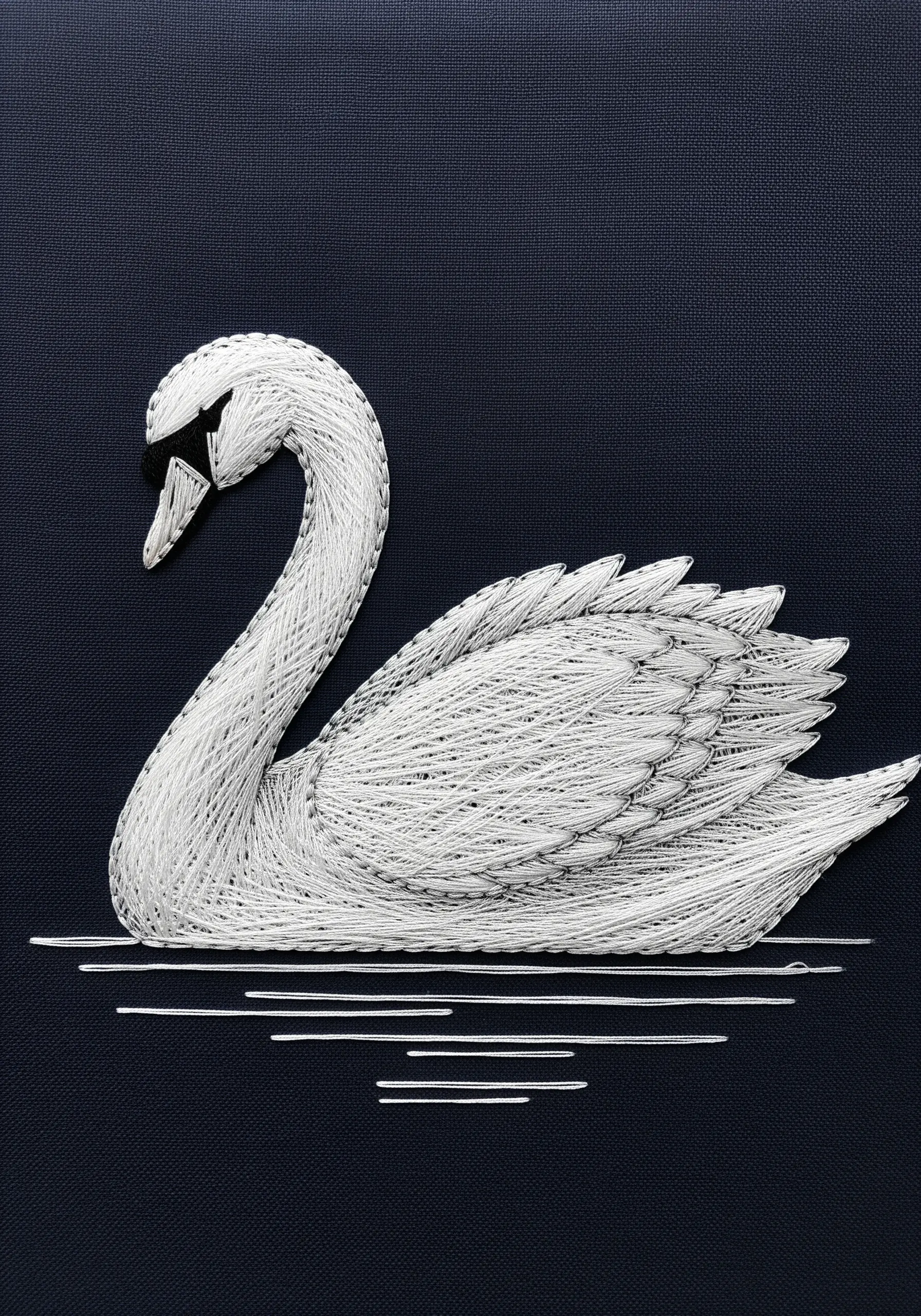 Elegant white string art swan on a dark navy background, with subtle textural details on the wings.