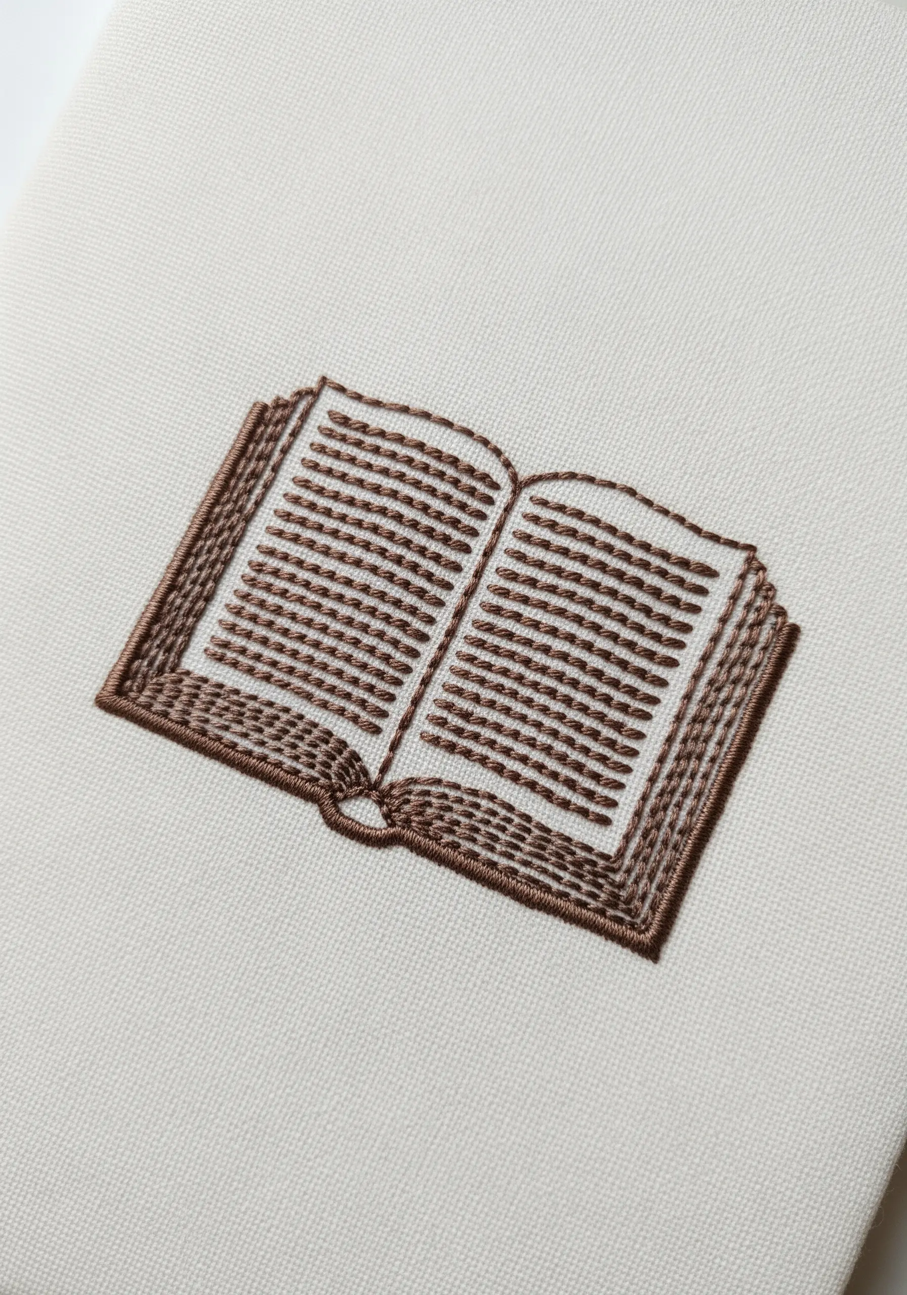 An embroidered open book with horizontal stitches representing lines of text.