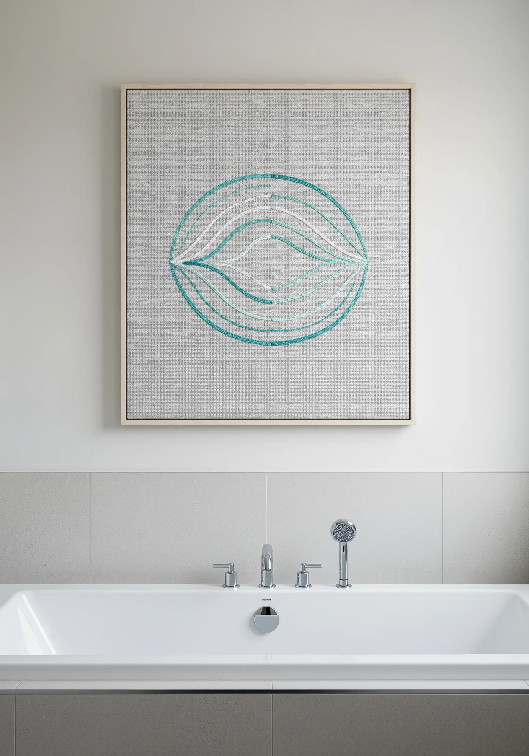 Framed embroidery with turquoise and white curved lines forming a symmetrical, eye-like shape.