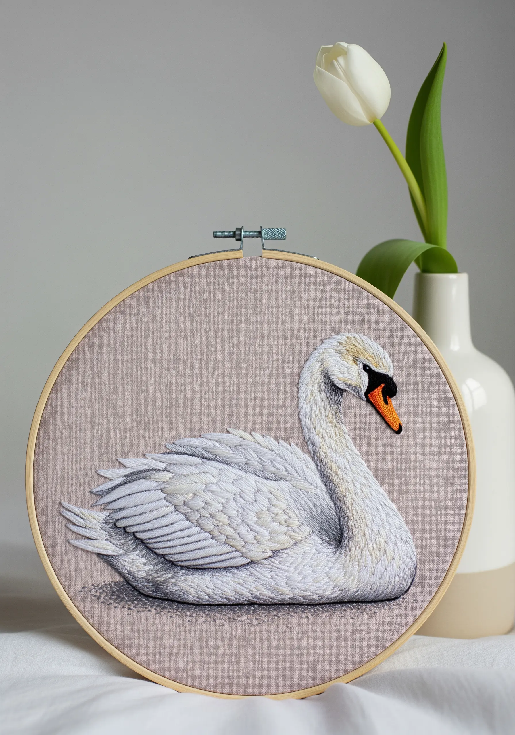 An elegant white swan embroidered with subtle grey shading for dimension.