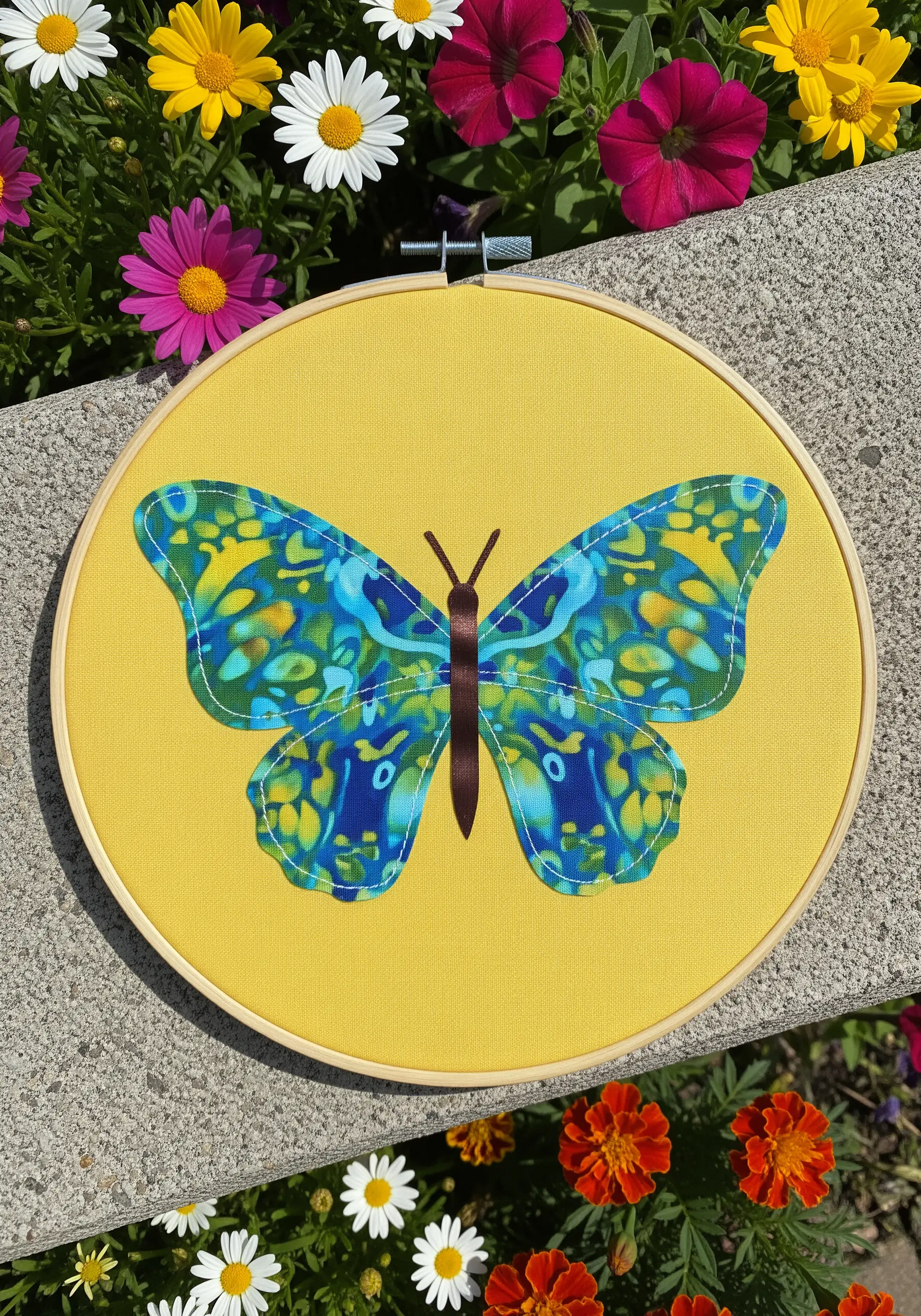 A symmetrical butterfly collage made from a vibrant blue and yellow batik fabric.