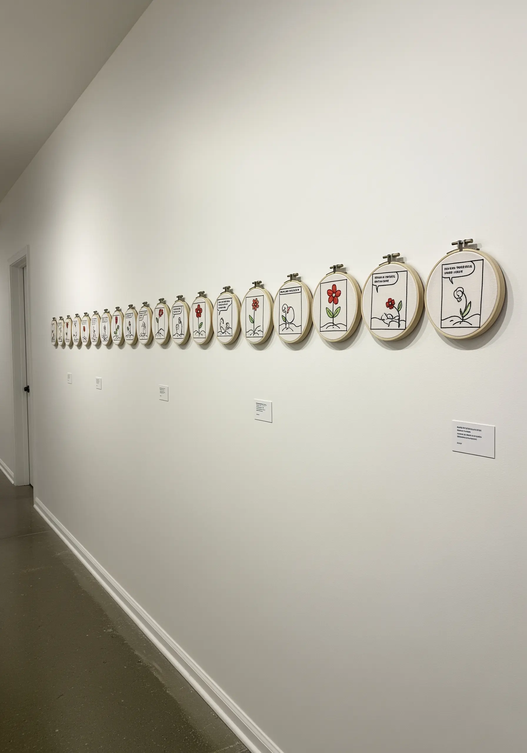 A long horizontal line of small embroidery hoops telling a comic-strip story about a flower.