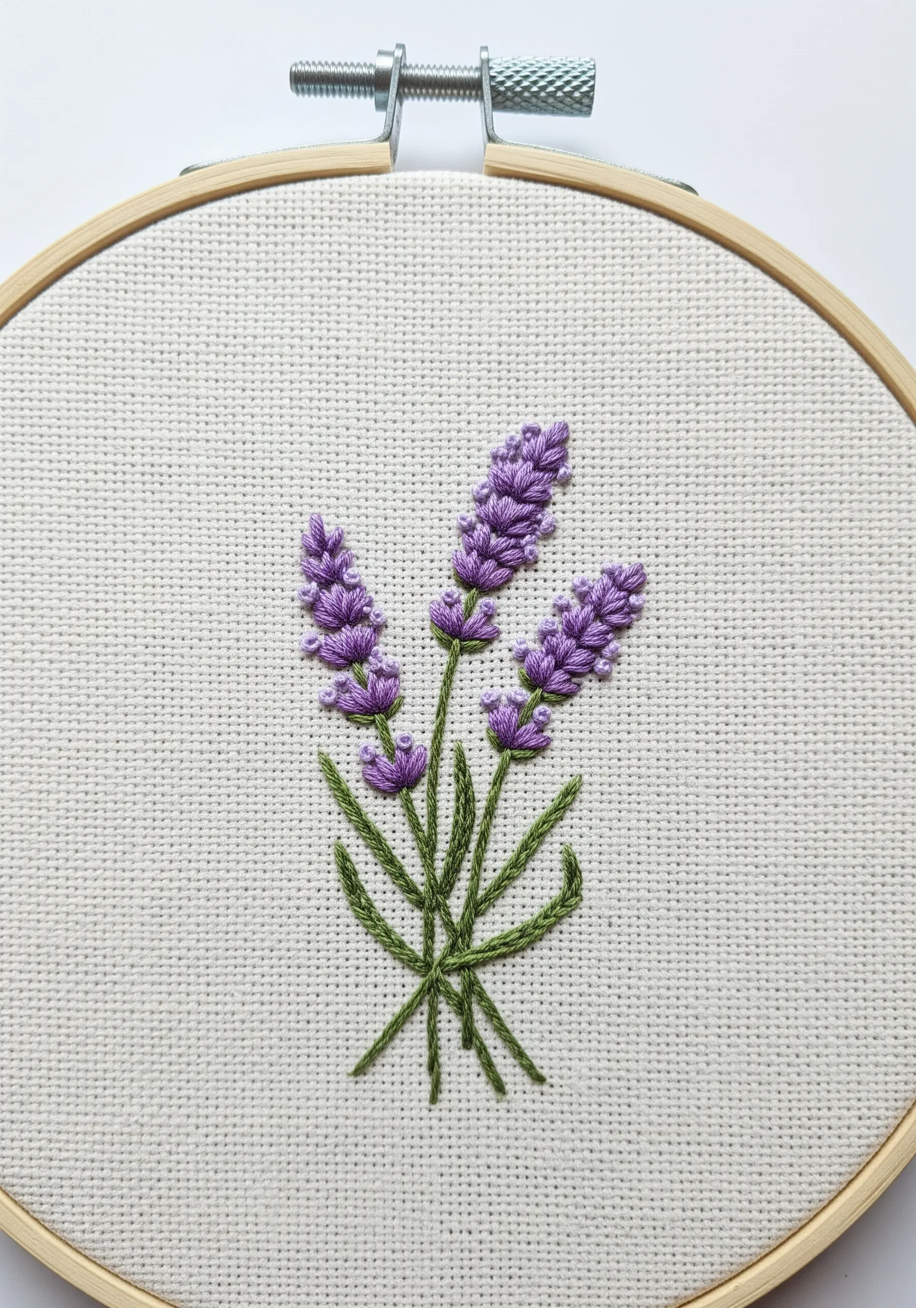 Lavender bouquet with purple French knots and green straight stitch stems.