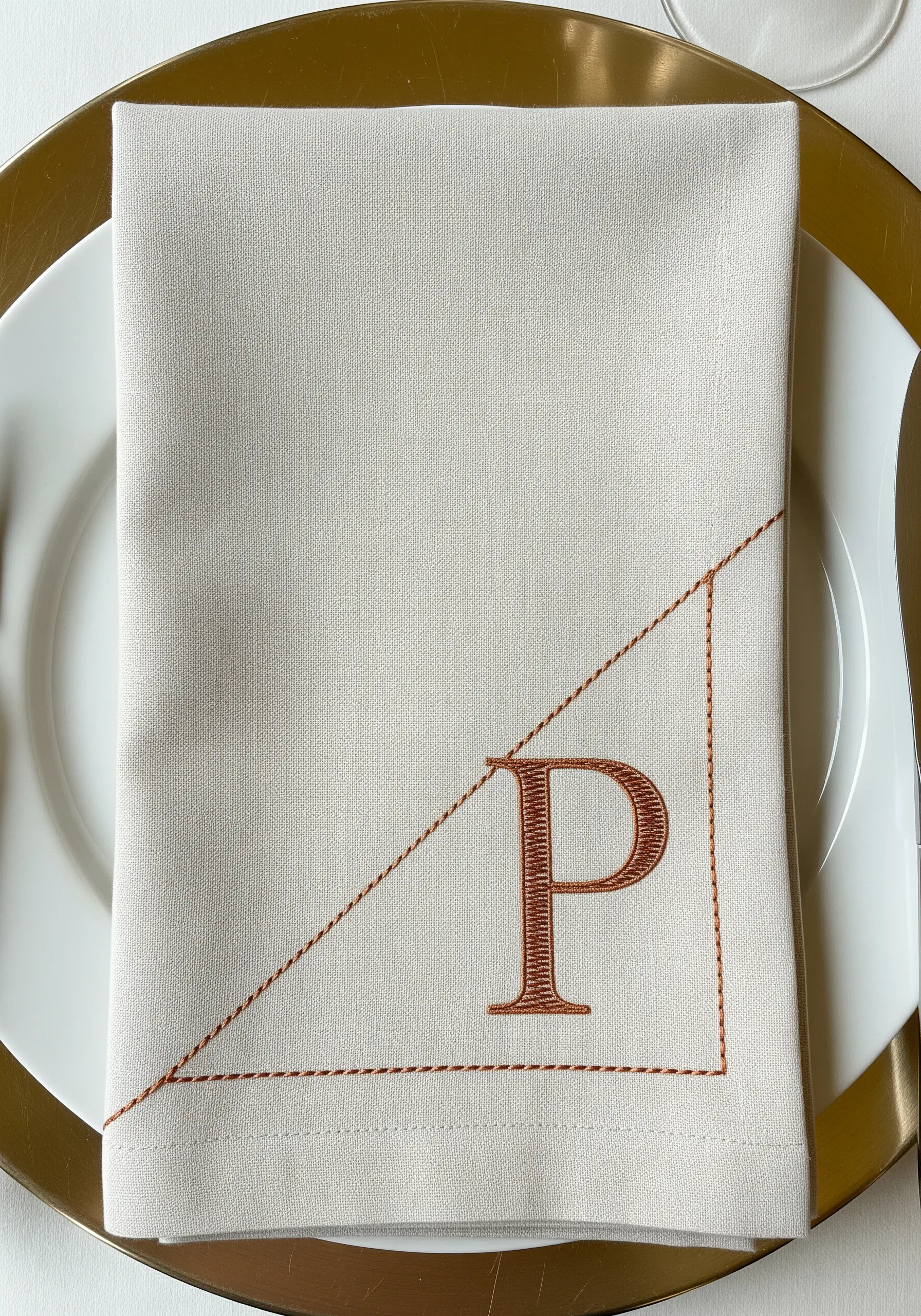 Satin stitch 'P' on a napkin framed by asymmetrical running stitch lines.