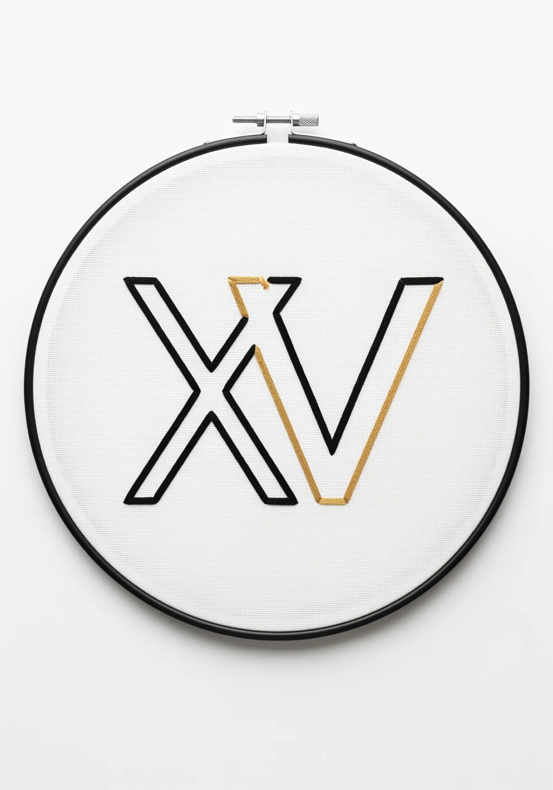 Modern 'XV' monogram in black and gold outline stitch on white Aida cloth.